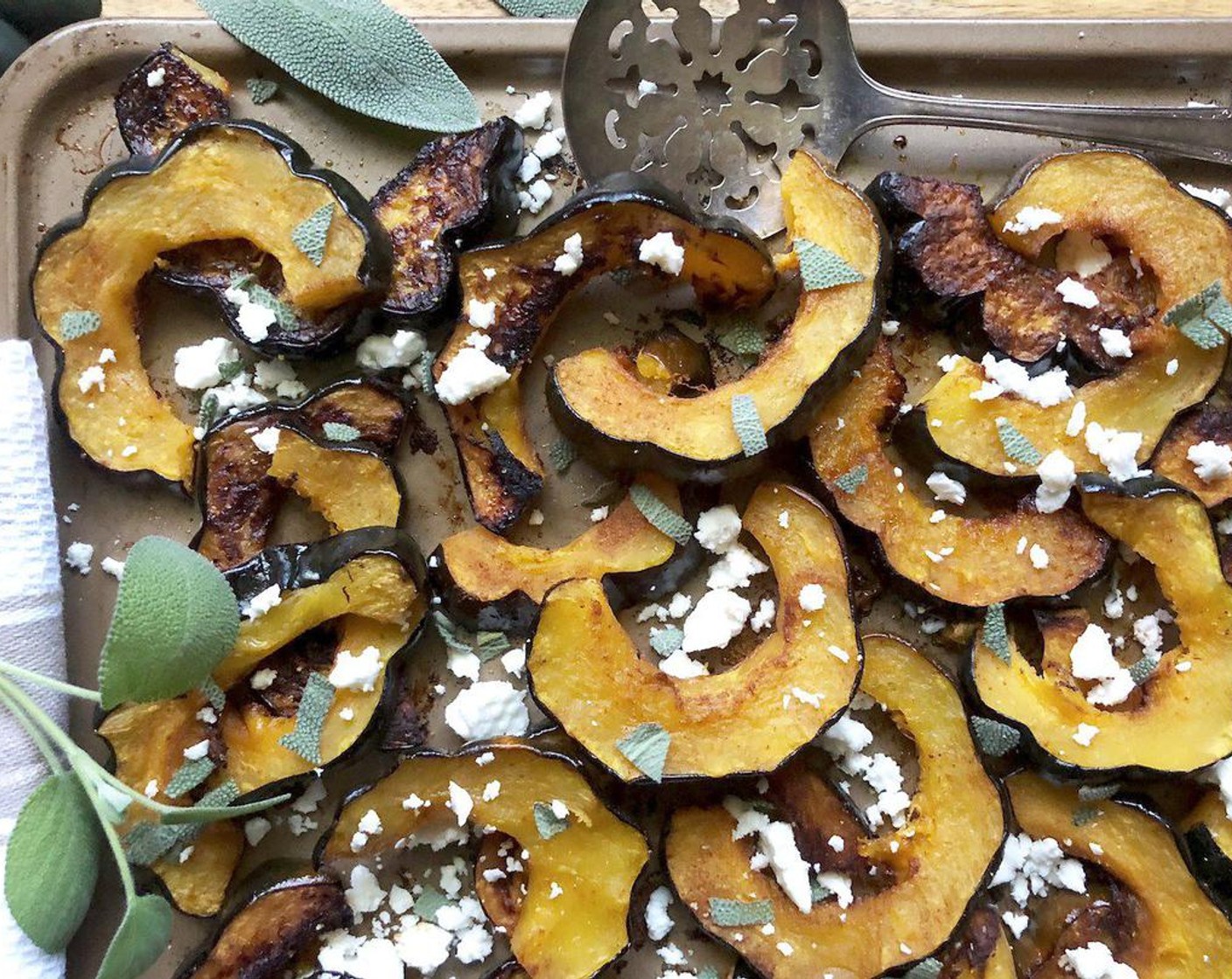 step 3 Bake for 30 to 35 minutes or until tender with caramelized edges, switching racks halfway through. Transfer the roasted squash to a serving platter; sprinkle with Sage Leaves (6) and Crumbled Feta Cheese (1/2 cup). If desired, garnish with additional fresh sage leaves. Serve immediately and enjoy!