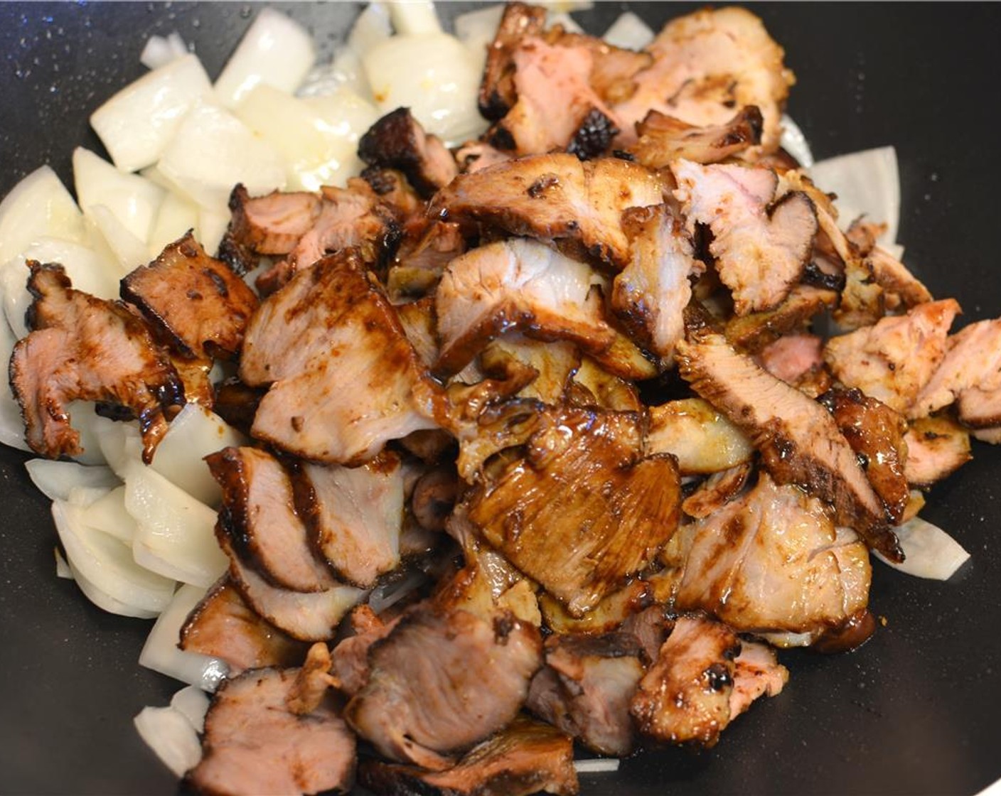 step 10 Then add in the sliced pork and toss it well with the onion.