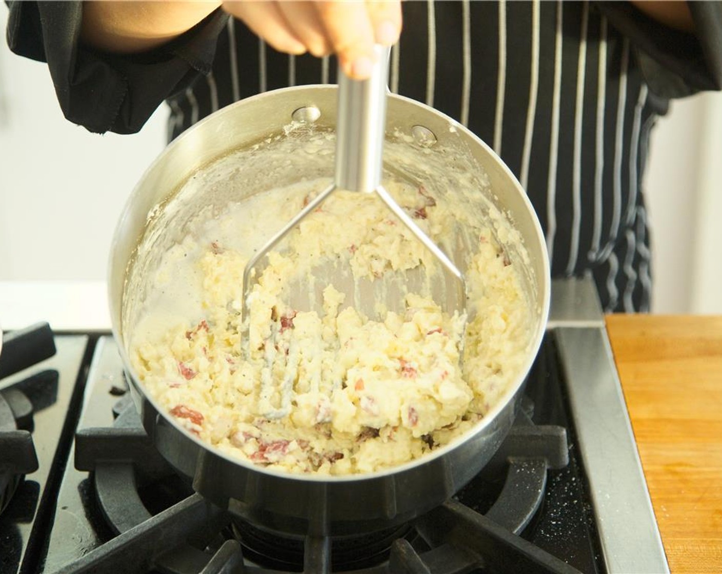 step 11 Using a potato masher, smash potatoes with Butter (1/4 cup), Sour Cream (2 Tbsp), Whipping Cream (2 Tbsp), Salt (1/2 tsp), and Ground Black Pepper (1/4 tsp). Cover and heat.