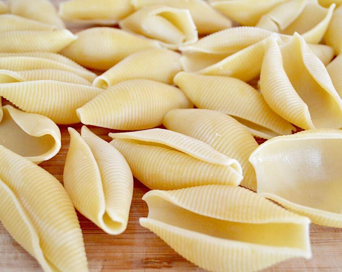 step 6 Meanwhile, bring a large pot of water to a boil and cook the Jumbo Pasta Shells (25) in it until tender, about 7-8 minute. Drain them and lay them out on a clean surface to let them cool enough to handle.