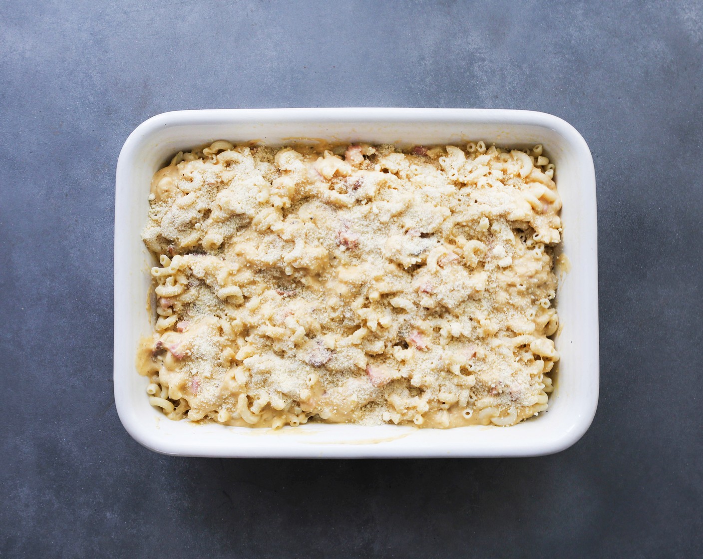 step 8 Pour the cheese-meat mixture over top of the pasta in the baking dish. Stir so the pasta is well-coated and top with Grated Parmesan Cheese (1/2 cup).