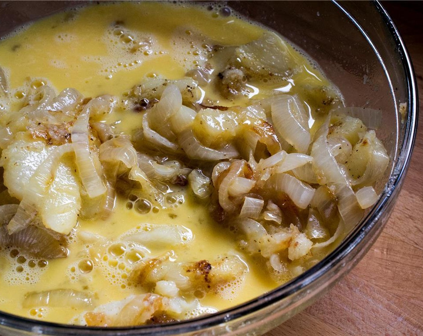 step 8 Add the potatoes and onions to the beaten eggs, pressing them down until they are completely submerged.  Let mixture stand for 10-15 minutes.