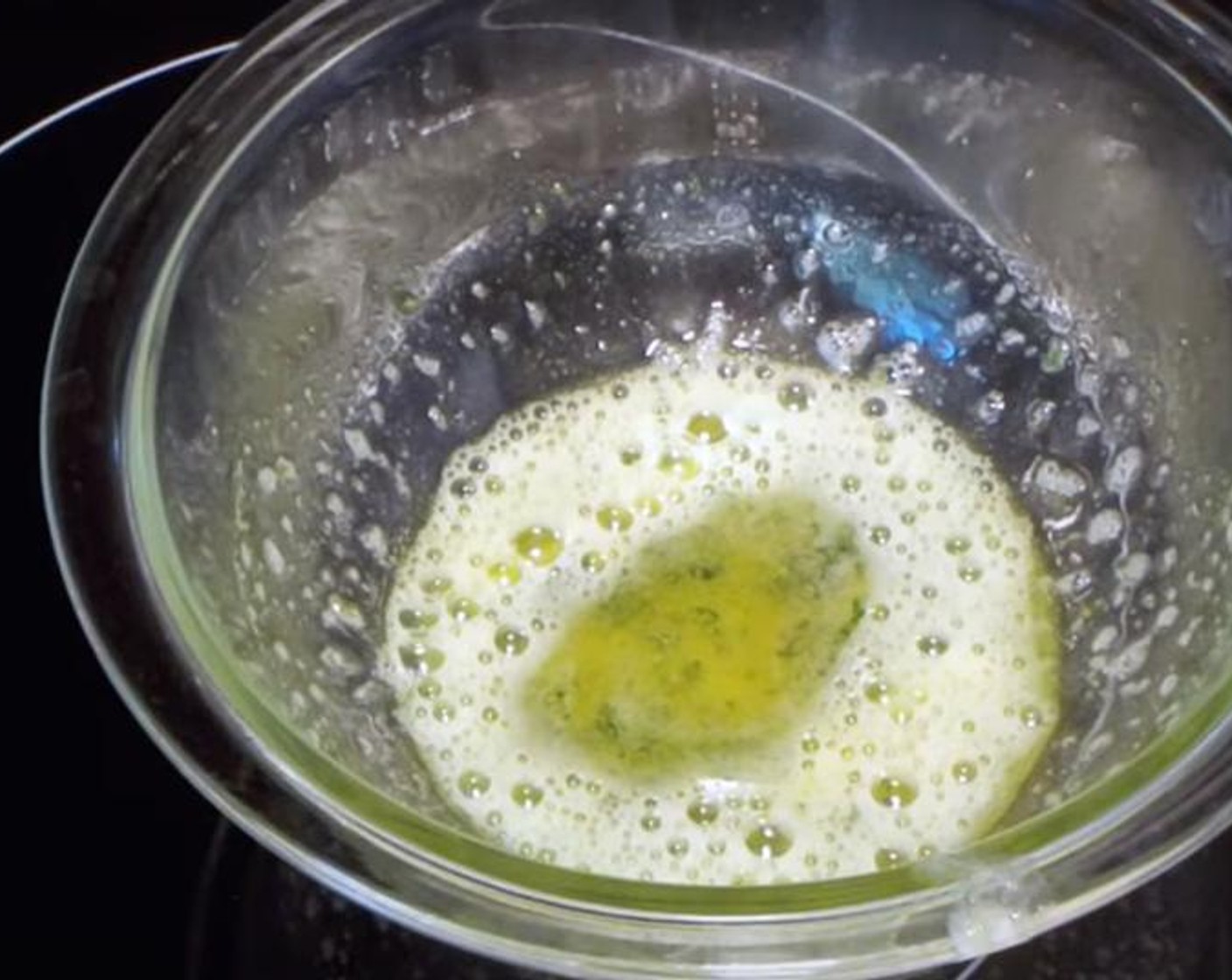 step 5 For the sandwich: in a pan, melt Butter (4 Tbsp). Add smashed and cut Garlic (3 cloves). Cook on medium low heat while stirring, then put it on low heat and cook for two minutes, before pouring it into a bowl. Add Dried Parsley (1 Tbsp).