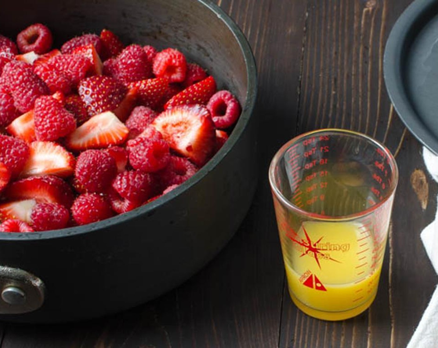 step 2 In a heavy-bottomed saucepan, heat the fresh strawberries, Fresh Raspberries (1 1/3 cups), and Orange (1/2) over medium-high heat until the fruit starts to break down and soften for about 5 to 10 minutes.