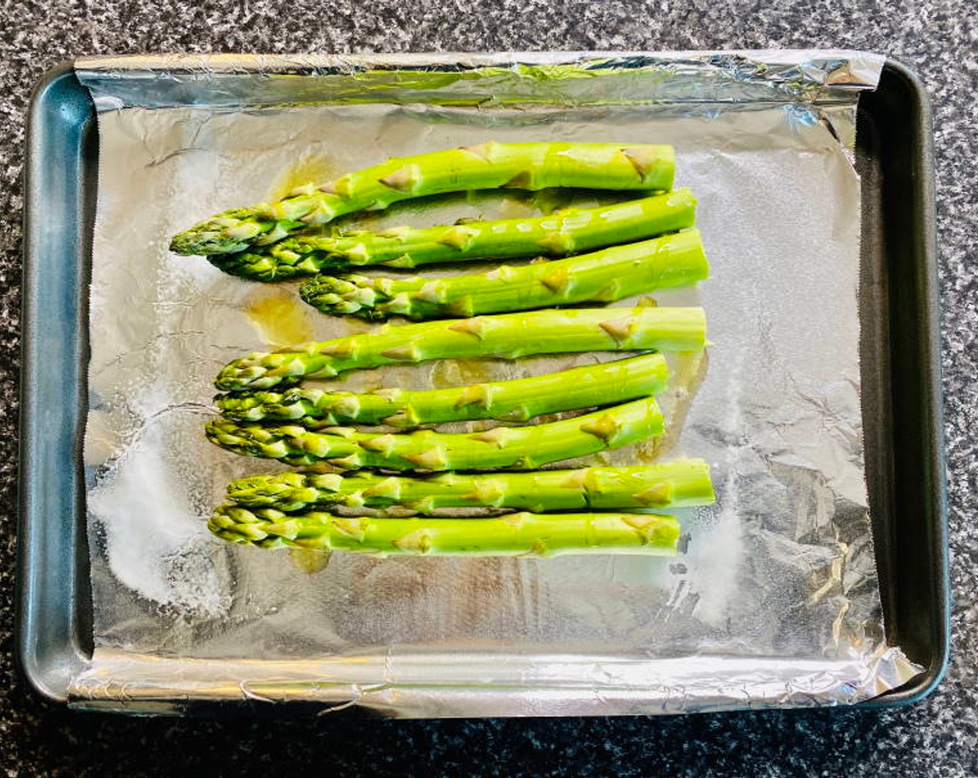 step 2 Place Asparagus (6) on a foil lined tray and drizzle with Garlic Infused Olive Oil (1 Tbsp) and lightly season with Salt (1 tsp), and Ground Black Pepper (1/2 tsp).