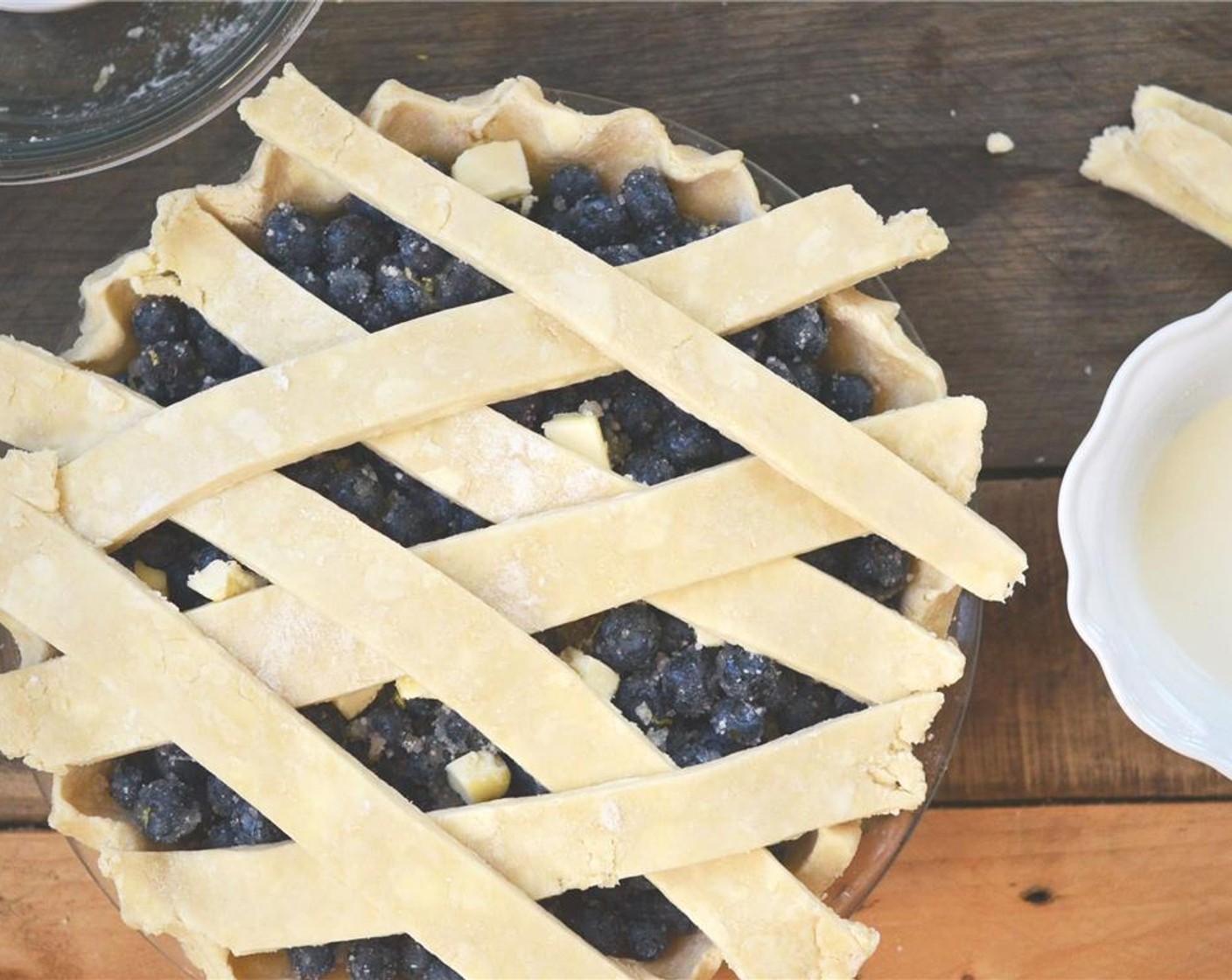 step 13 Taking strips of pie crust, lay them across the pie, either using a lattice pattern or any which way. Crimp the edges of the pie crust, folding under excess pie crust along the edges.