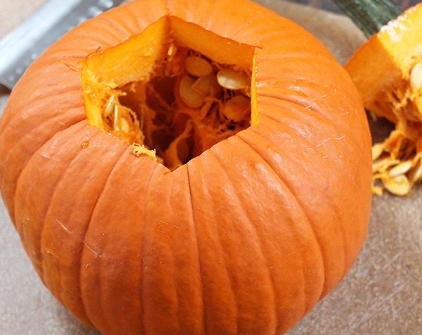 step 4 Prep your Pumpkin (1). Make vertical cuts around the stem and remove it as you would for a jack-o-lantern. Carefully cut the pumpkin in half lengthwise and, using a spoon, remove the seeds and pulp. Save the seeds for the optional maple-roasted pumpkin seeds, or discard.