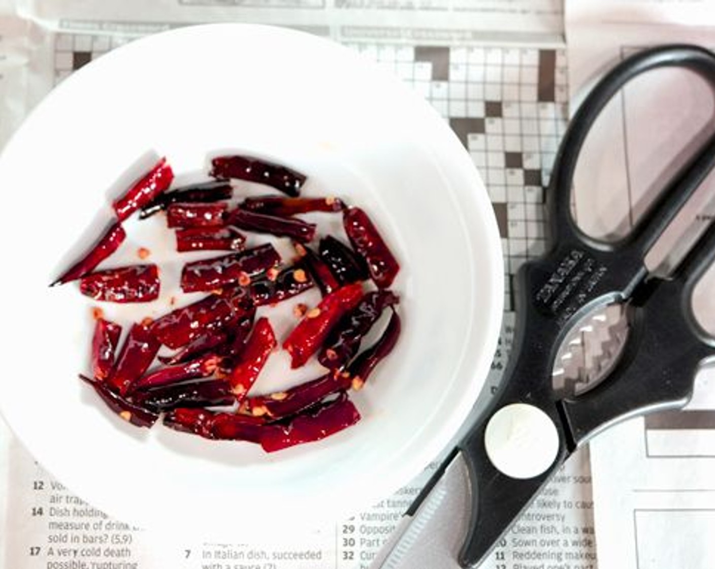 step 5 Add the Dried Chili Peppers (6) and gently stir them around the wok until they get crispy– about 20 seconds. Be careful not to burn them! Transfer to a strainer and hold the strainer above the wok to let any oil drip back into it. Empty the chilies into a small bowl. Once they aren't too hot to handle, cut each dried red chili up into two or three pieces with cooking scissors, cut the longer ones into three pieces and the shorter ones into two.