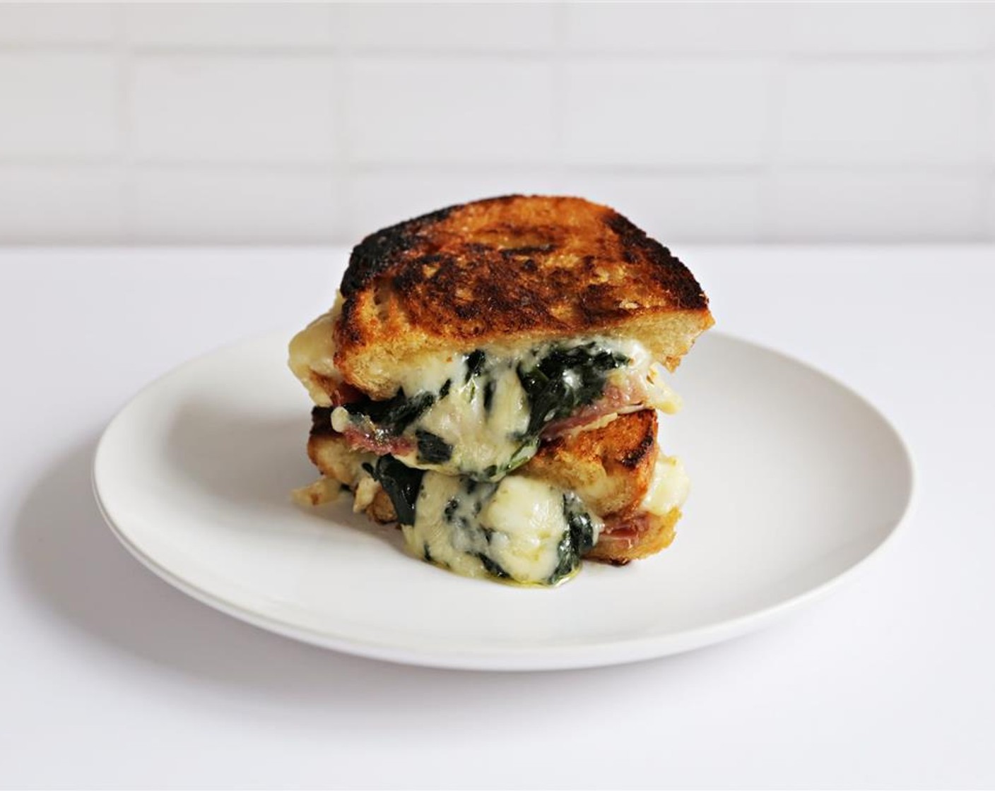 step 9 Cut in half and serve immediately, while cheese is still melty.
