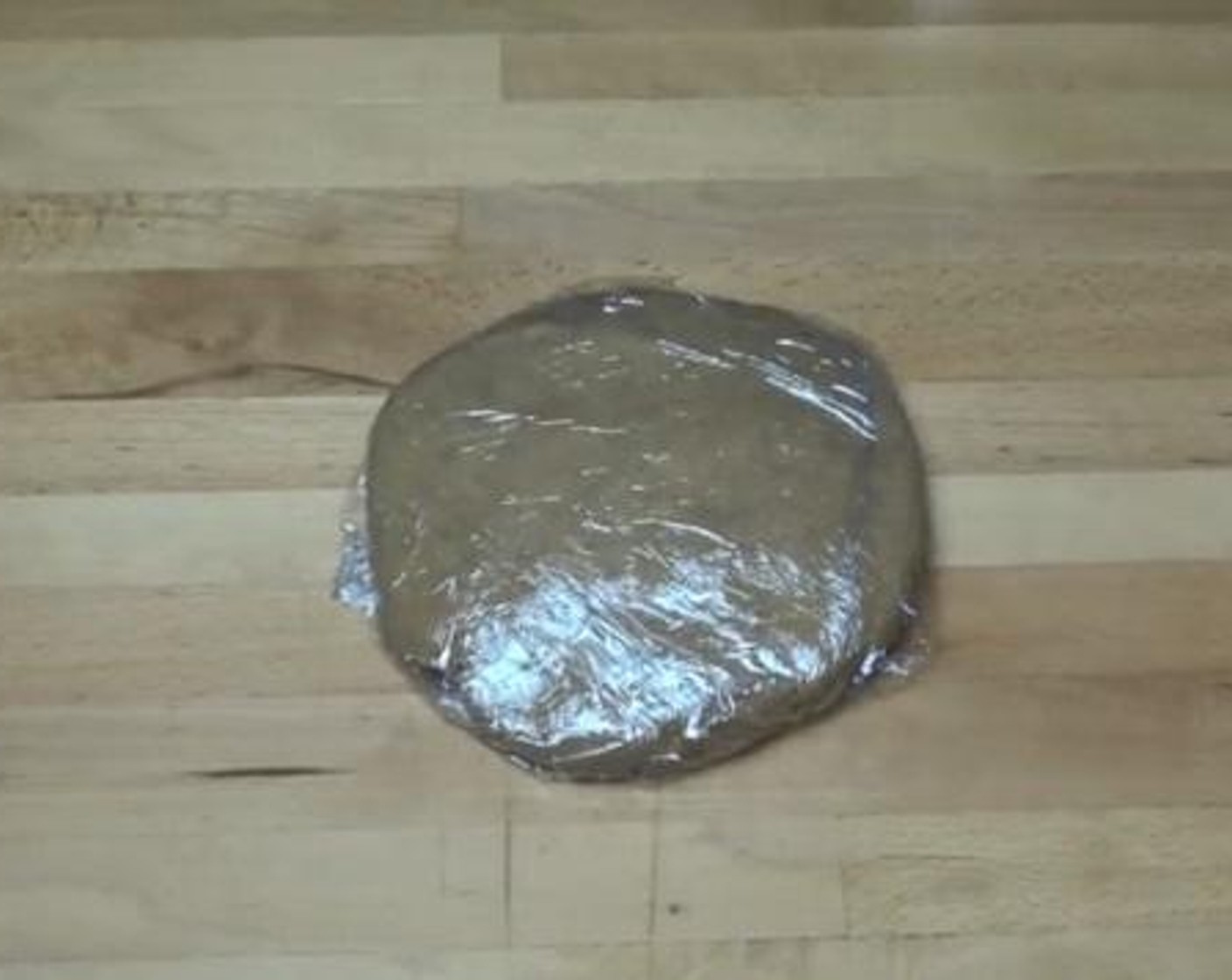 step 3 Form the dough into a shape of a disk, and wrap it up with some kitchen wrap. Place it into the fridge for about 1 hour.
