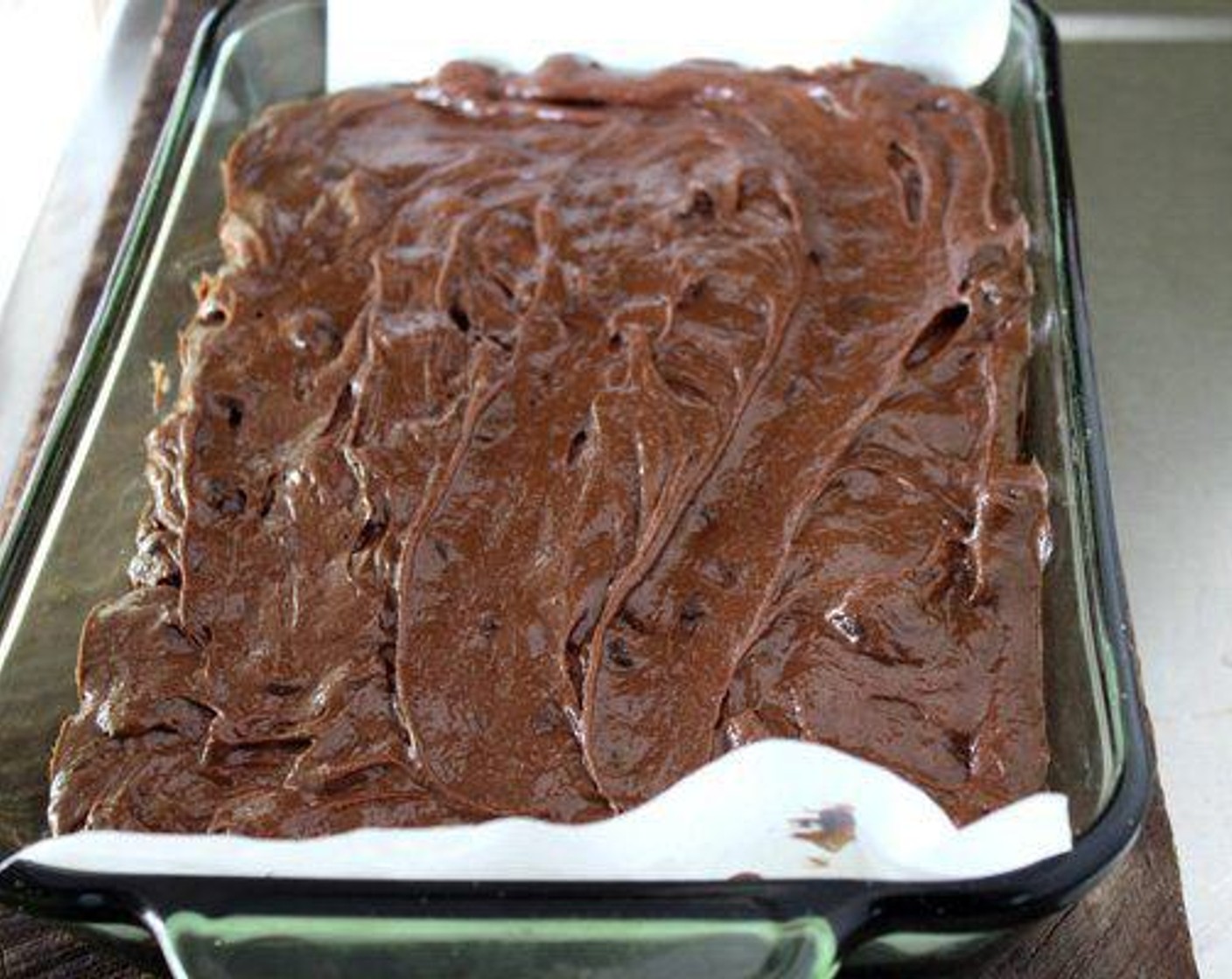 step 6 Pour the brownie mixture into the baking dish and spread evenly. Top with the cheesecake mixture. Using a spoon, swirl the cheesecake into the brownies.