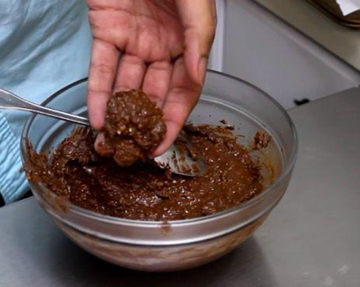 step 3 Take the Nutella batter out of the freezer, scope some and use hand to form a small ball. Push a Hazelnuts (15) into the center and roll it smooth. Roll in the crushed wafer.