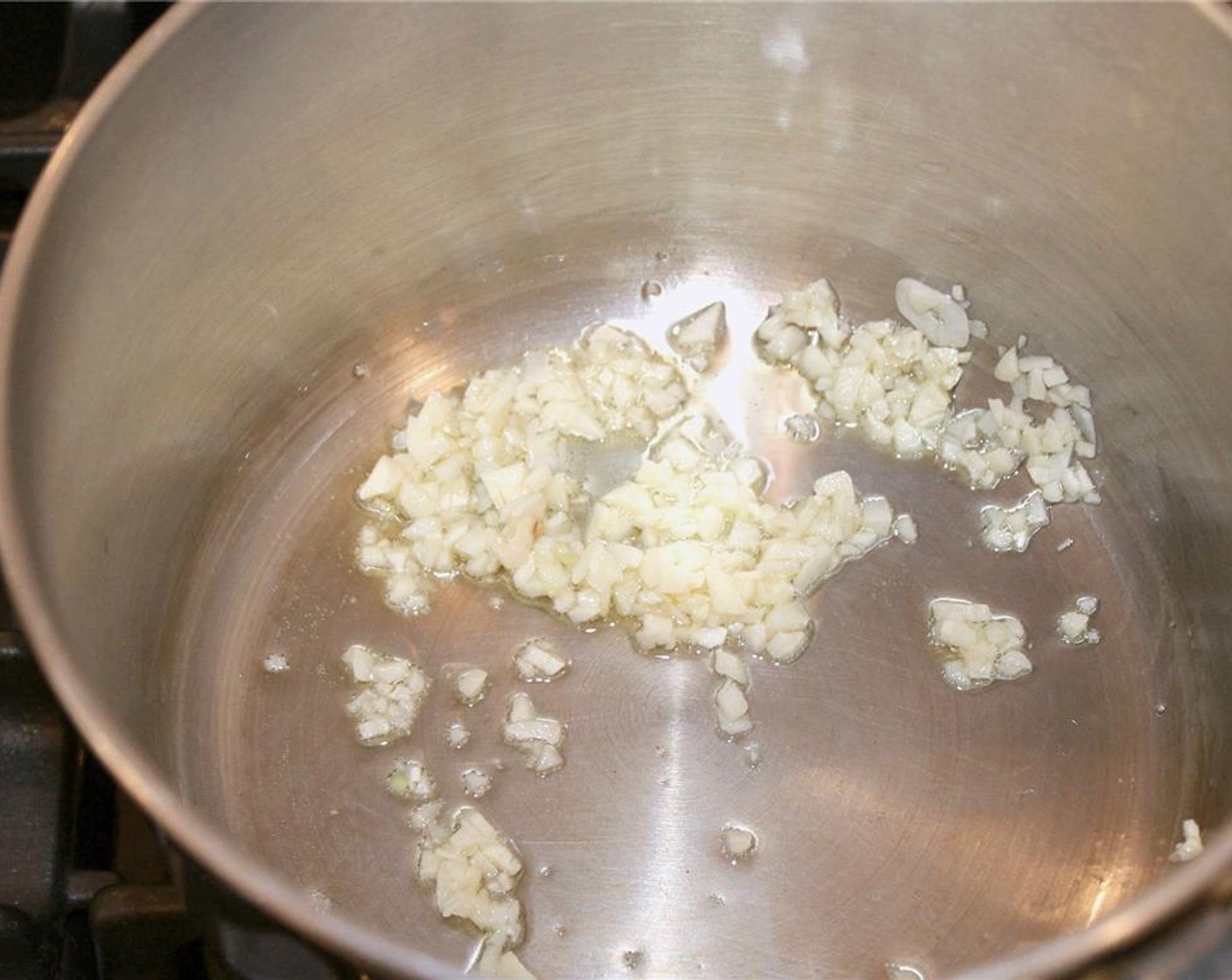 step 4 Sauté half of the minced garlic in the olive oil until fragrant, about 30 seconds. Immediately stir in the Canned Crushed Tomatoes (1 2/3 cups), Dried Oregano (2 tsp), basil and Salt (1 tsp). Let simmer over low heat while you continue prepping the rest of the ingredients.
