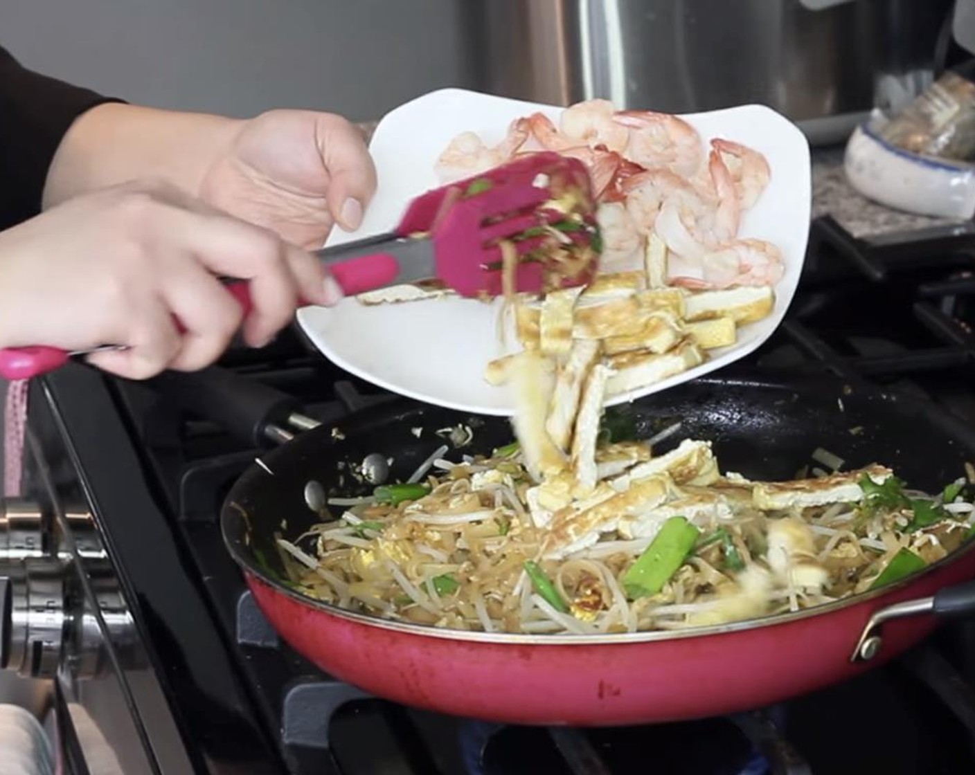 step 18 Add the cooked tofu and shrimp back to the pan. Toss again and remove from heat.