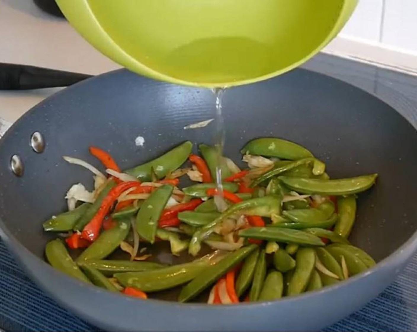 step 3 Then add the Garlic (1 clove). Stir and add the Sugar Snap Peas (1 cup) and stir again. Add a splash of water to get the cooking going without adding extra oil. Leave to cook for a couple of minutes