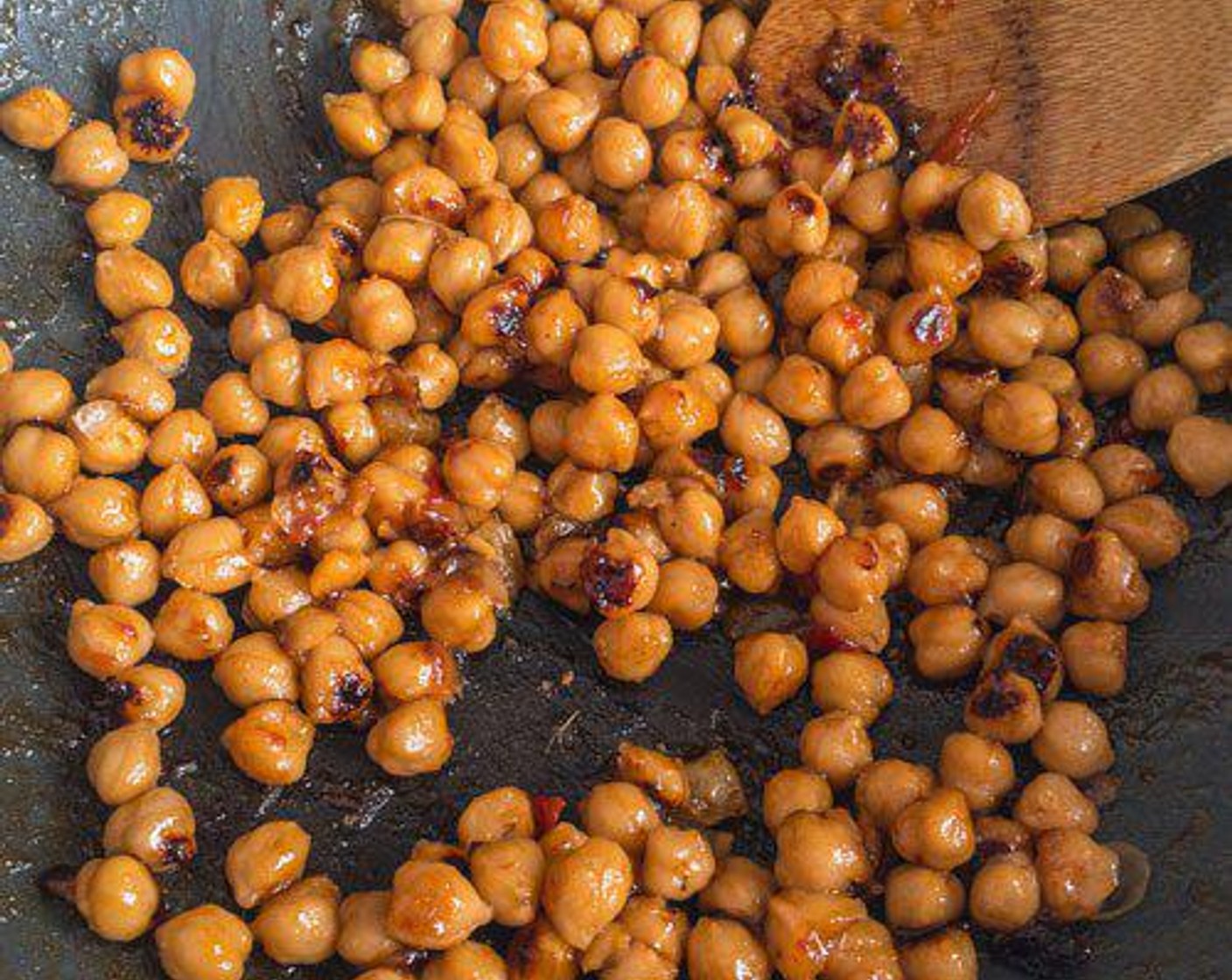 step 2 In an extra large frying pan or wok, add Grapeseed Oil (1 Tbsp), Chickpeas (1 can), and Mango Ginger Chutney (1/3 cup). Cook covered on medium-high for about 5 minutes, stirring about every minute. Chickpeas should be slightly charred. Push to the side of the pan.