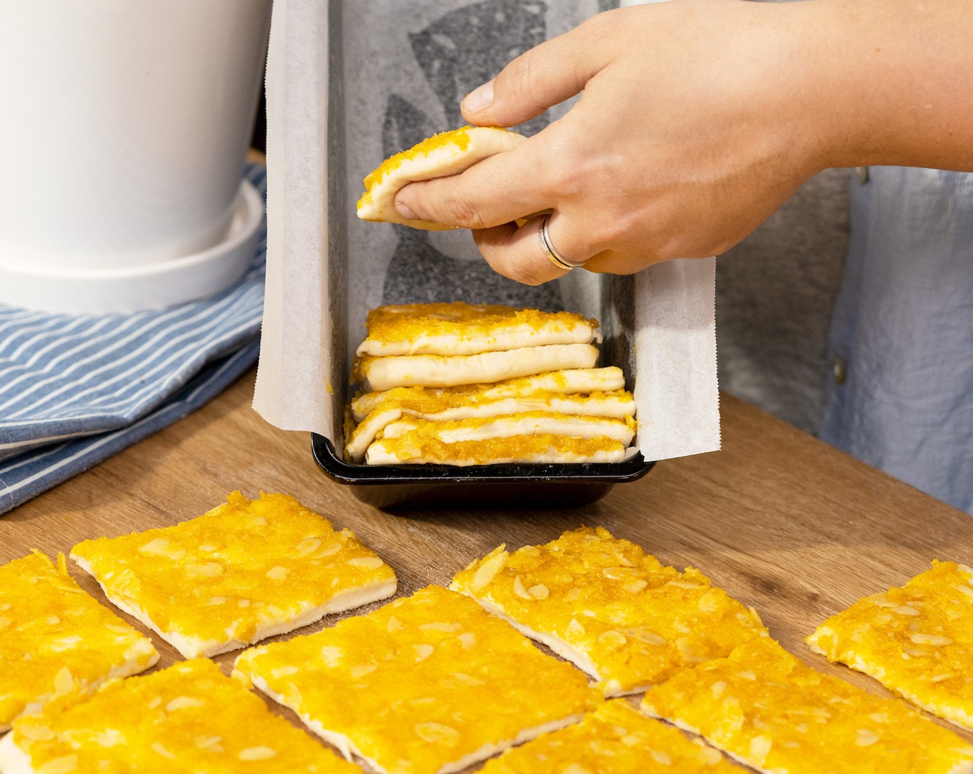 step 6 Tilt the loaf pan on its side and stack the dough pieces, then set it down.