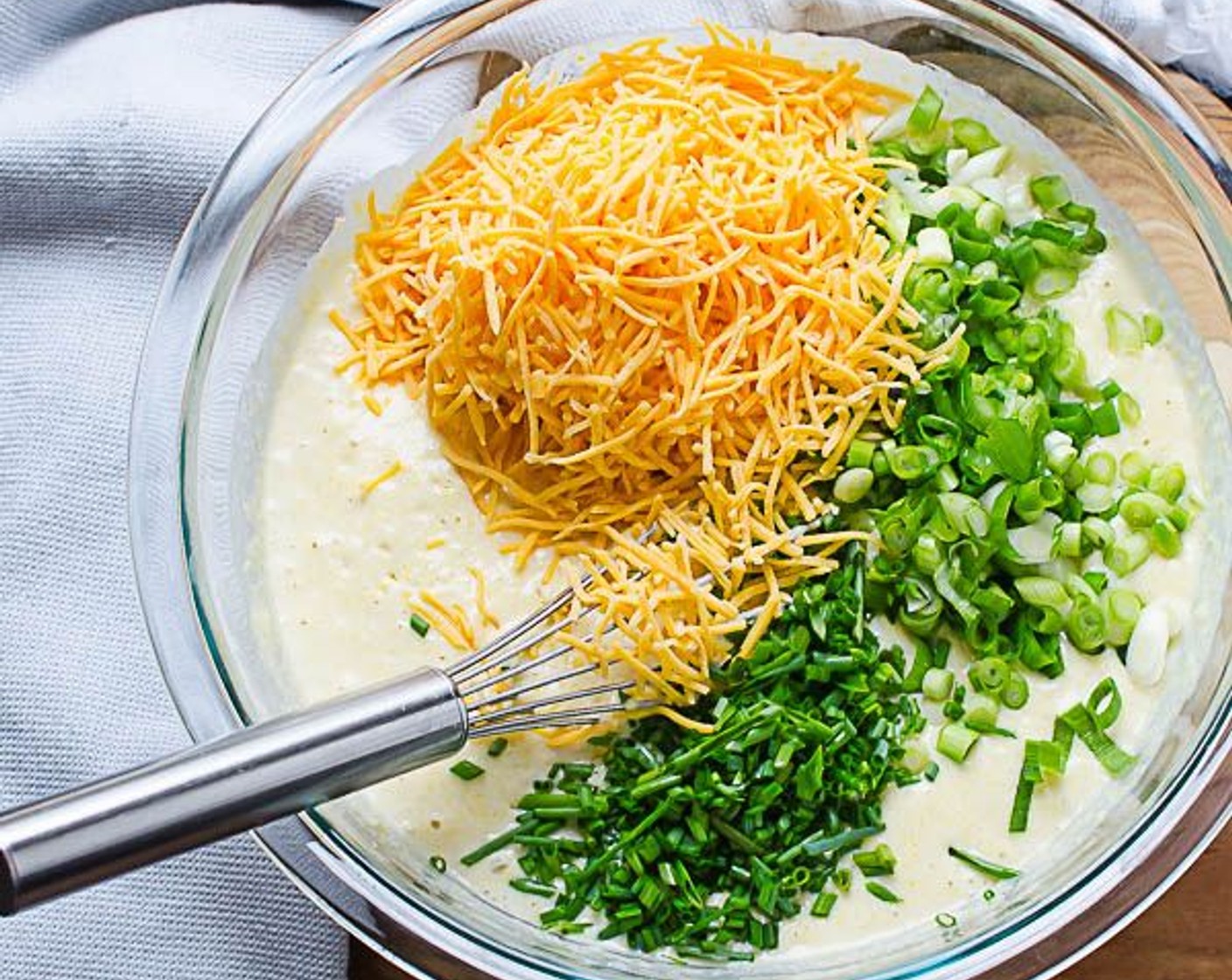 step 11 Add wet ingredients to dry ingredients and stir until just mixed. Stir in the Shredded Cheddar Cheese (1 cup), Scallion (1 bunch), and Fresh Chives (1 Tbsp).