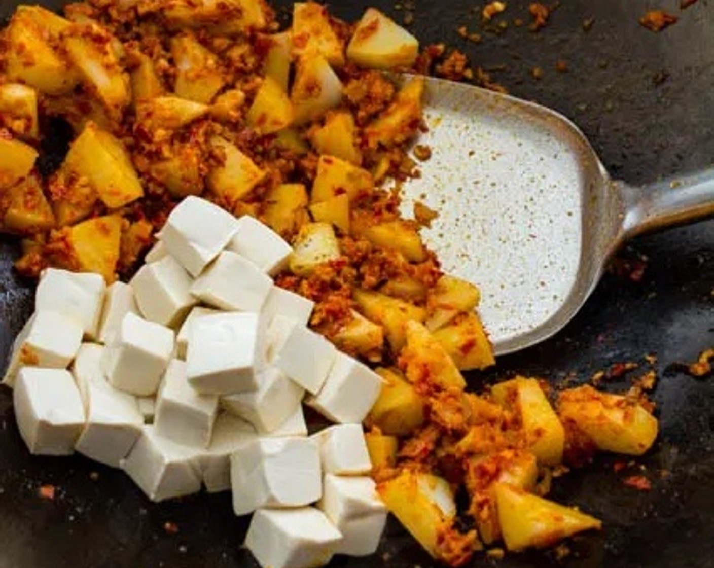 step 9 Add the potatoes to the wok, followed by the Extra Firm Tofu (1 cup). Gently stir-fry to coat the tofu and potatoes in the sambal.