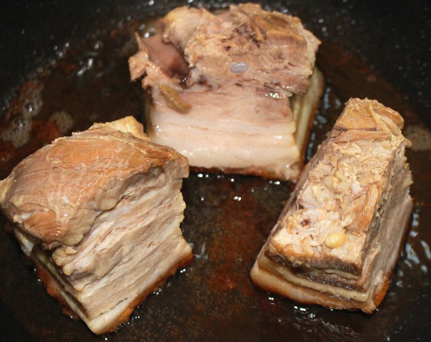 step 4 Cut the pork belly into 3 pieces, then fry on the skin side only, until golden brown and crisp.