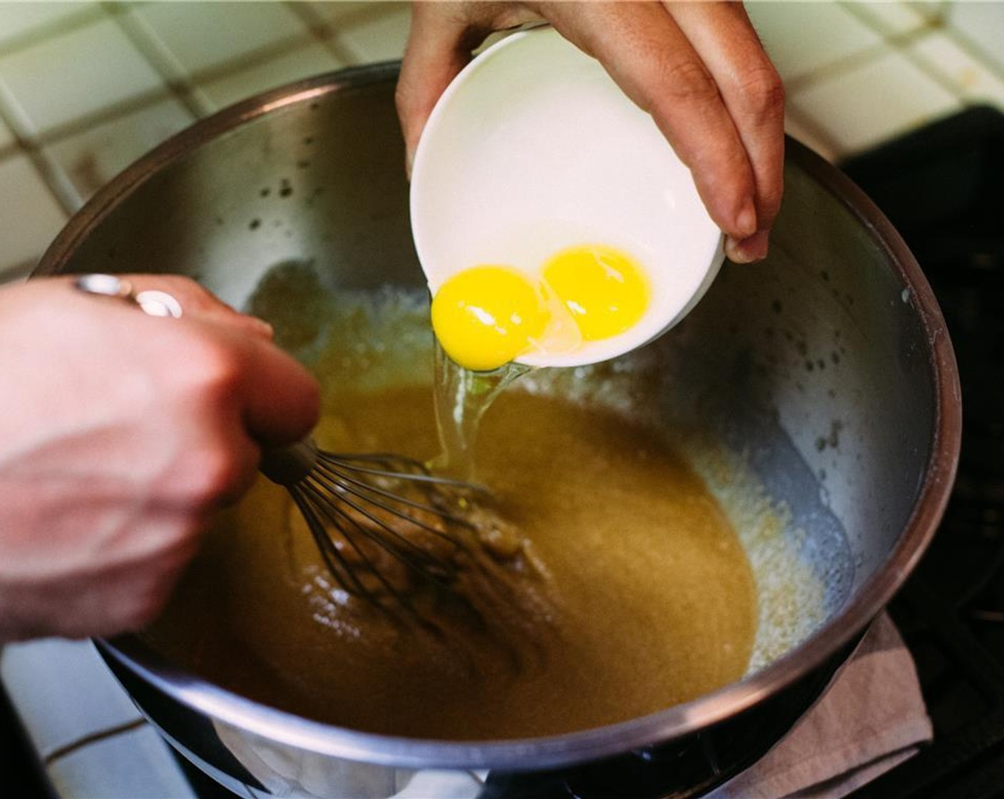 step 3 Pour butter into a large bowl. Add Dark Brown Sugar (1 cup) and Maple Sugar (1 cup) and whisk until combined. Whisk in Eggs (2), one at a time.