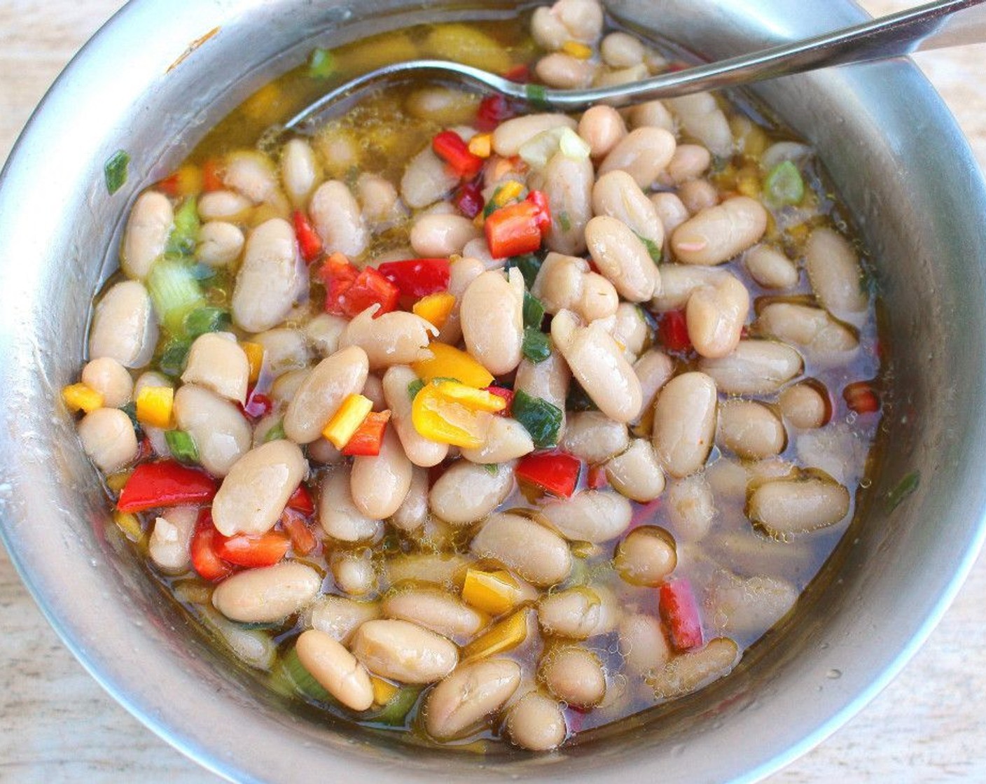 step 1 In a mixing bowl, combine Cannellini White Kidney Beans (1 can), Assorted Color Bell Peppers (1/2 cup), Scallion (1/4 cup), Extra-Virgin Olive Oil (1/2 cup), Garlic Paste (1/2 tsp), Apple Cider Vinegar (to taste), Cayenne Pepper (to taste), and Kosher Salt (to taste).
