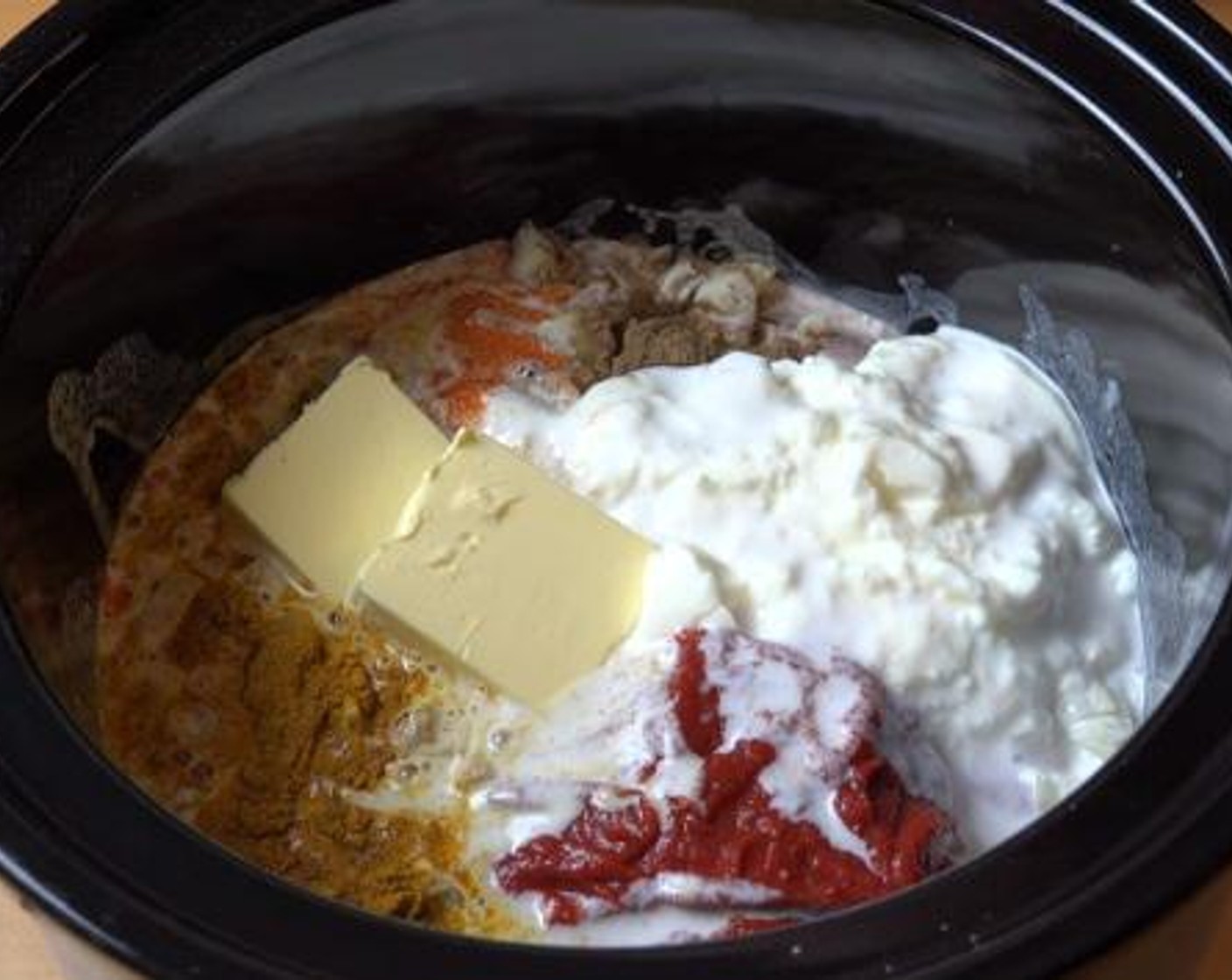 step 1 Add the Boneless, Skinless Chicken Breasts (4), Yellow Onion (1), Curry Powder (1 Tbsp), Chili Powder (1 tsp), Garam Masala (1 Tbsp), Garlic (3 cloves), Tomato Paste (1/2 cup), Natural Unflavored Yogurt (1 cup), Coconut Milk (1 2/3 cups), Butter (3.5 oz), Salt (to taste), and Ground Black Pepper (to taste).