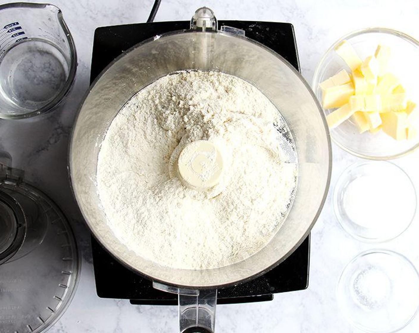 step 1 In the bowl of a food processor, pulse the All-Purpose Flour (2 1/2 cups), Granulated Sugar (2 Tbsp) and Kosher Salt (1/2 tsp) together. Cut the Unsalted Butter (1 cup) into small pieces, then add to the food processor. Pulse at 1-second intervals until butter is the size of peas. Add the Water (1/2 cup) and pulse again about 10 times until the mixture is crumbly but holds together when pinched.
