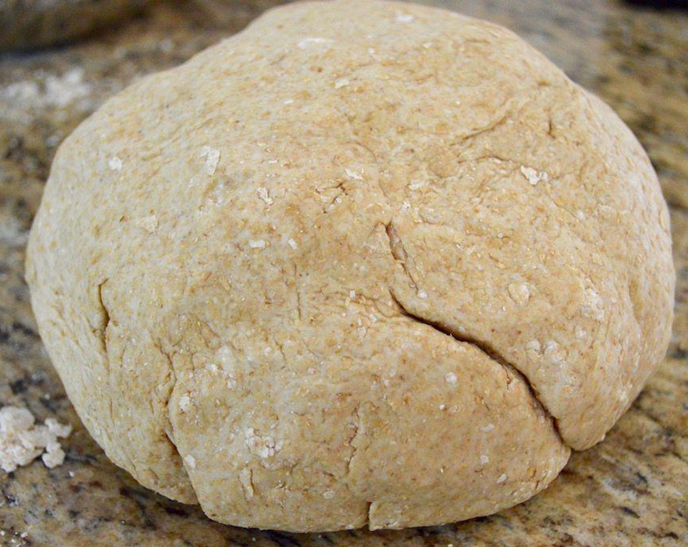 step 2 Then stir in the Olive Oil (4 Tbsp) followed by the Water (720 mL) to bring the dough together. Bring it together into a large ball and turn it out onto a clean, floured surface.