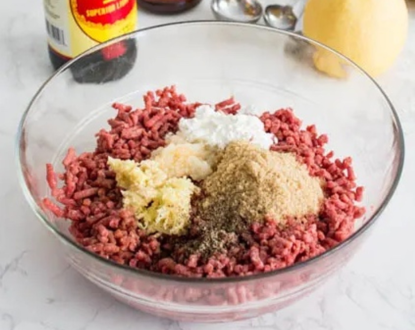 step 1 Pour Ground Beef (1 lb) into a medium-sized mixing bowl. Add Light Soy Sauce (3 Tbsp), Brown Sugar (3 Tbsp), Asian Pears (3 Tbsp), Sesame Oil (2 Tbsp), Corn Starch (2 Tbsp), Fresh Ginger (1 tsp), Garlic (3 cloves), and Ground Black Pepper (1 dash) to the beef. Mix thoroughly.