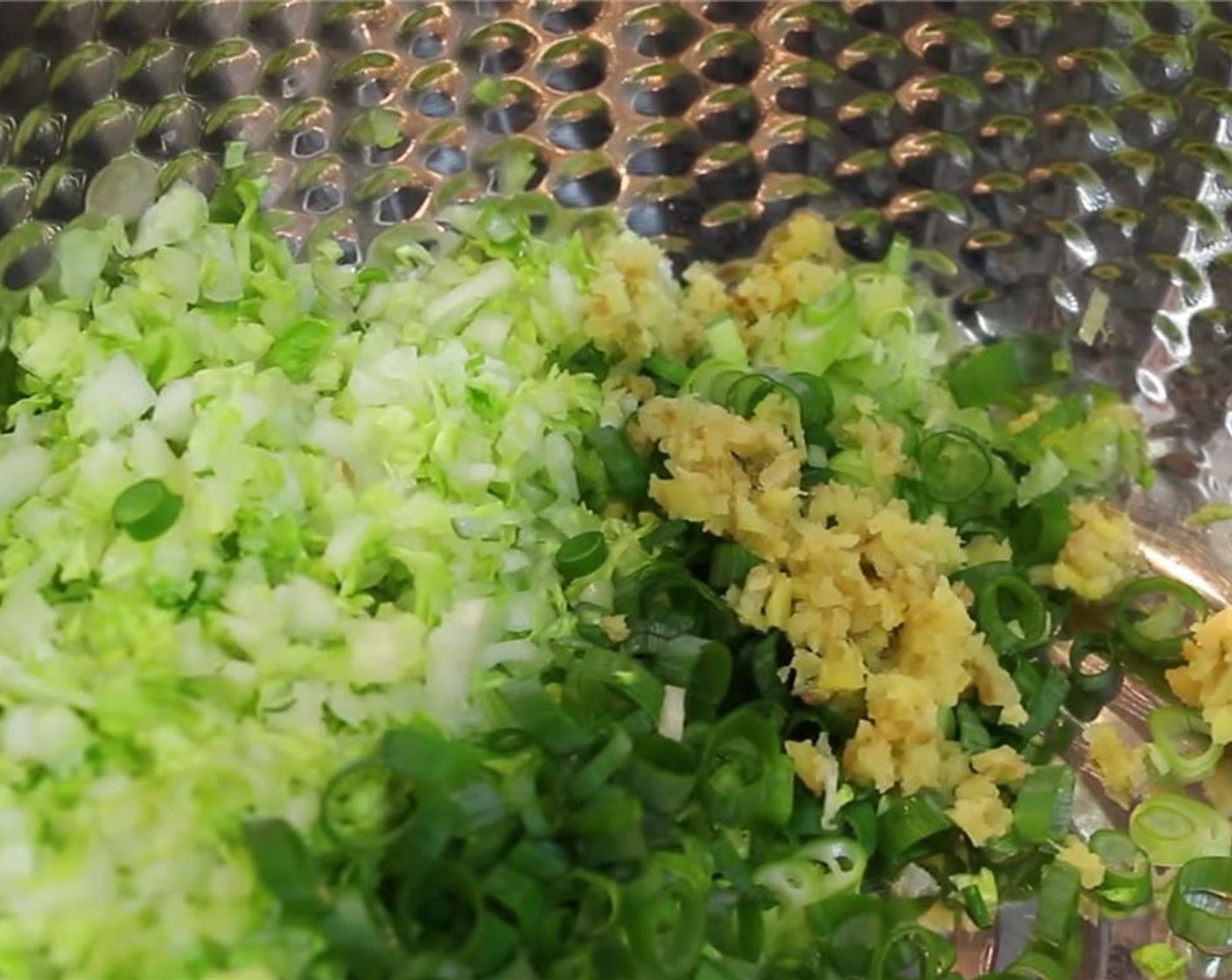 step 4 Add ginger and white part of green onion to the large bowl.