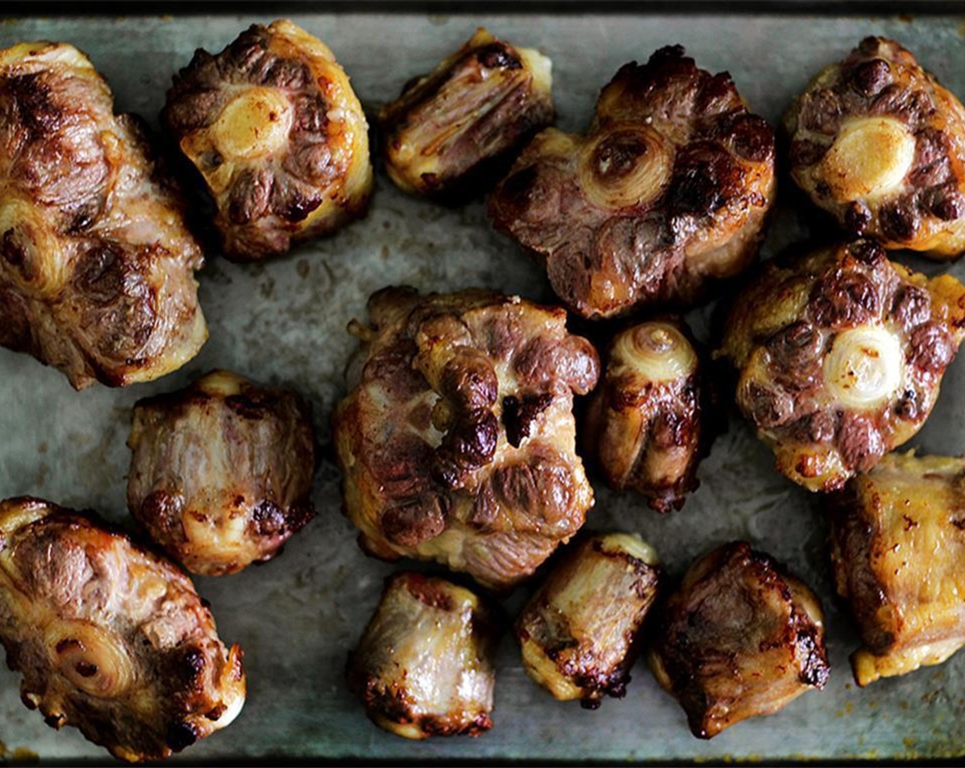 step 3 Drain the oil and leave only 2 tablespoons in the pan, and turn the heat down to MEDIUM. Add the Fresh Ginger (1/2 cup) and cook until they shrivel up and get nicely browned on the edges, about 5 minutes. Add oxtails back into the pan.