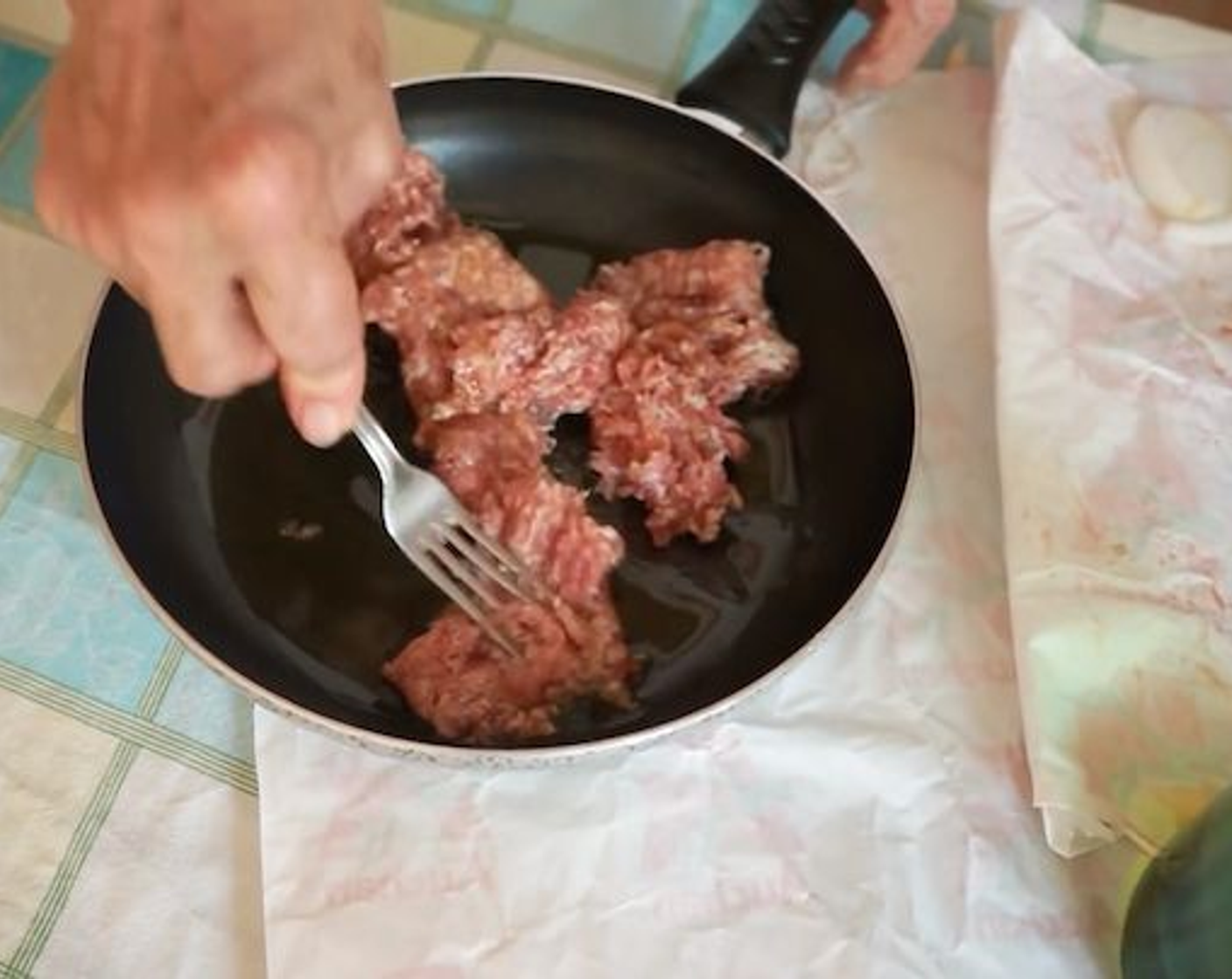 step 5 Now, it’s time to prepare the sausage you will add to the Italian cornmeal polenta. Get a medium-size frying pan and add some Extra-Virgin Olive Oil (as needed). Place de-skinned Italian Pork Sausages with Fennel (3) in the pan and break them up using a fork by squashing and pressing them forward. They are to be enjoyed in pieces, not whole.