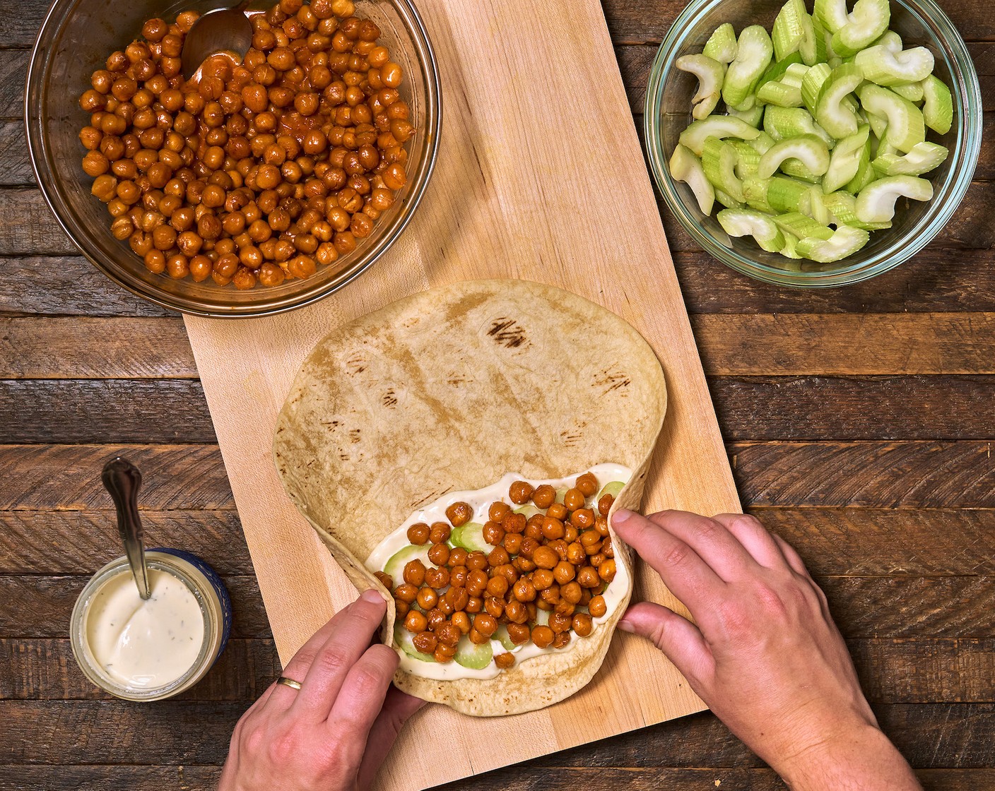 step 7 Roll into a burrito by gently folding on both sides. Lift up the bottom of the tortilla and cover the filling.