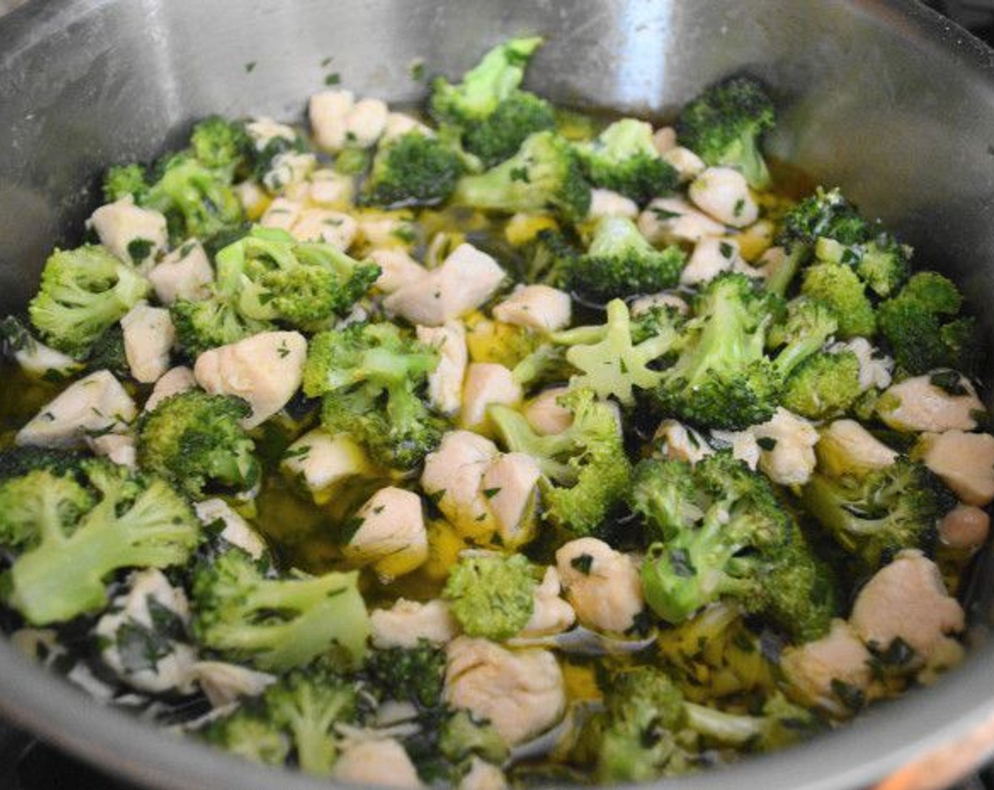 step 10 Take the broccoli out of the oven at this point and add it to the aglio olio sauce, along with the chicken chunks. Let all of the flavors meld together on low for another 15 minutes.