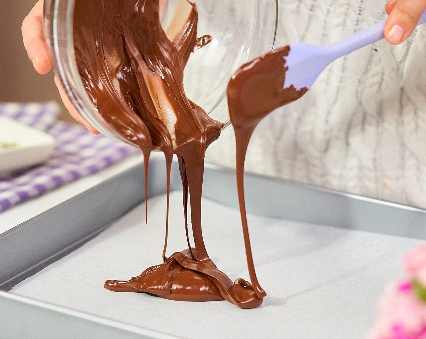 step 3 Pour the dark chocolate into the prepared baking tray, spreading it out to an even layer about 1/4-inch thick.