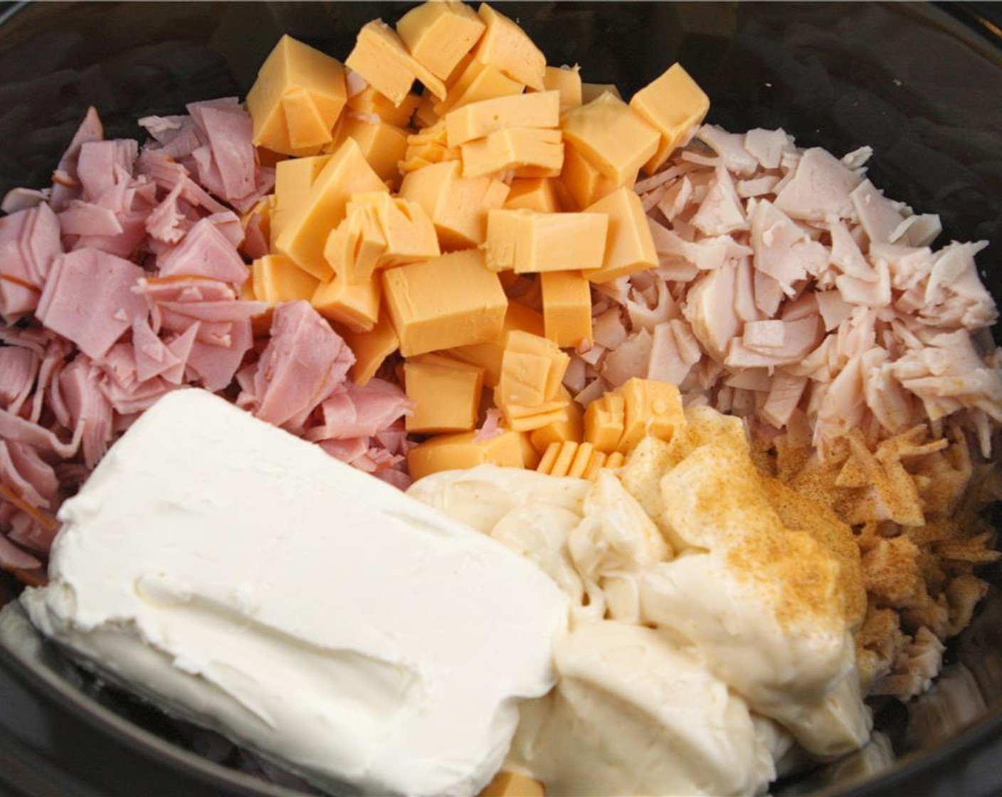 step 2 Add the sliced turkey, sliced ham, sliced american cheese, Mayonnaise (3/4 cup), Cream Cheese (1 cup), and Seasoned Salt (1 tsp) to a slow cooker.