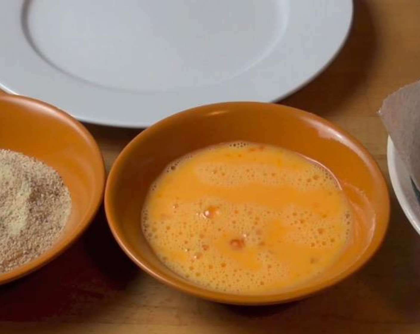 step 4 Dunk each chicken piece in the egg and milk mixture and then coat it in Breadcrumbs (1 1/2 cups). Place finished nuggets on a plate.