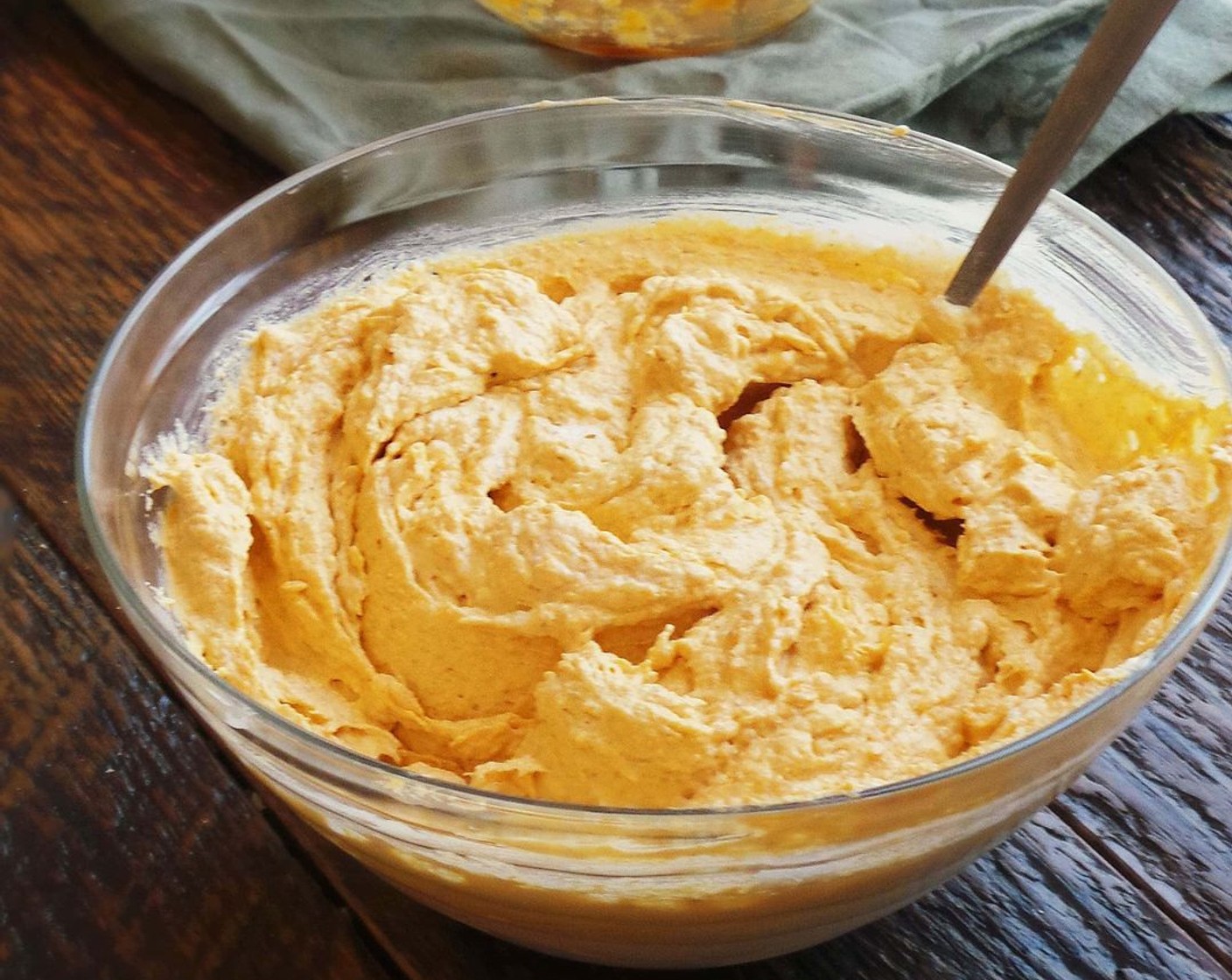 step 3 In a large bowl, mix the Whipped Topping (1 tub), Pumpkin Purée (1 can), Instant Vanilla Pudding (1 box), and Pumpkin Pie Spice (1 tsp) until combined. Transfer into the tub and place in the pumpkin.