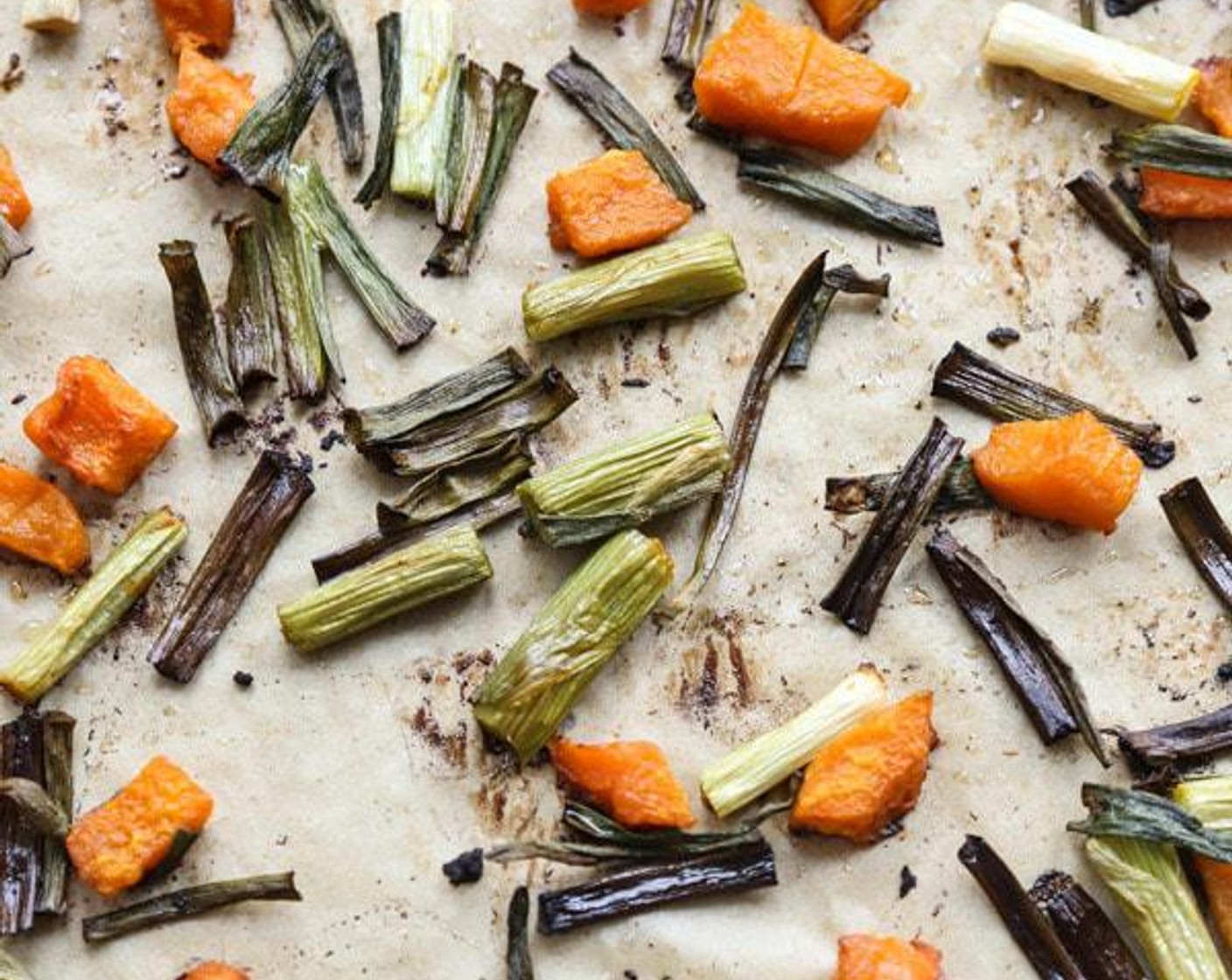 step 2 On a parchment-lined baking sheet toss the Butternut Squash (4 cups) with Olive Oil (as needed) and Sea Salt (to taste). Arrange in an even layer and roast in the oven for 15 minutes, until soft but not beginning to caramelize. Add the Scallion (1 bunch) and toss to coat in the olive oil.