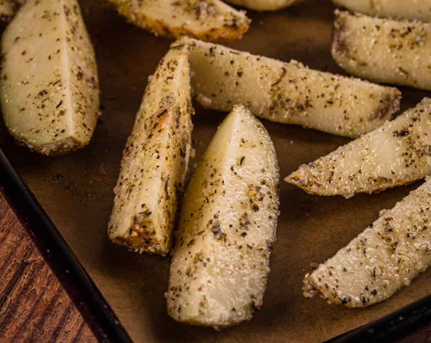 step 4 Place seasoned potato wedges on the prepared sheet pan making sure they are evenly spaced and in one layer.