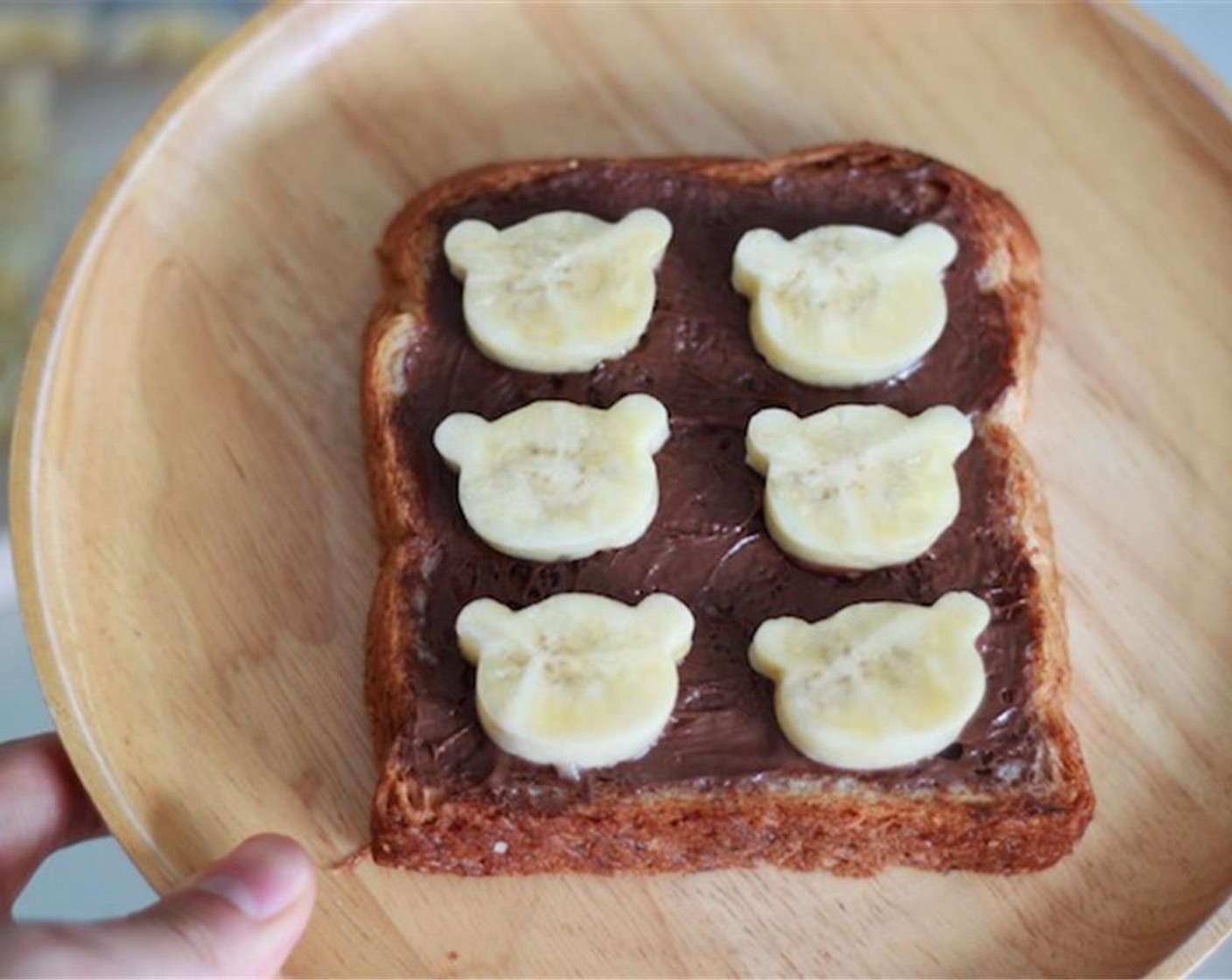 step 2 Take a piece of Whole Wheat Bread (1 slice) and cover it with Nutella® (2 Tbsp). The pour some Nutella in a plastic squeezer for drawing on Rilakkuma's face. Gently place your 6 bears on the toast.