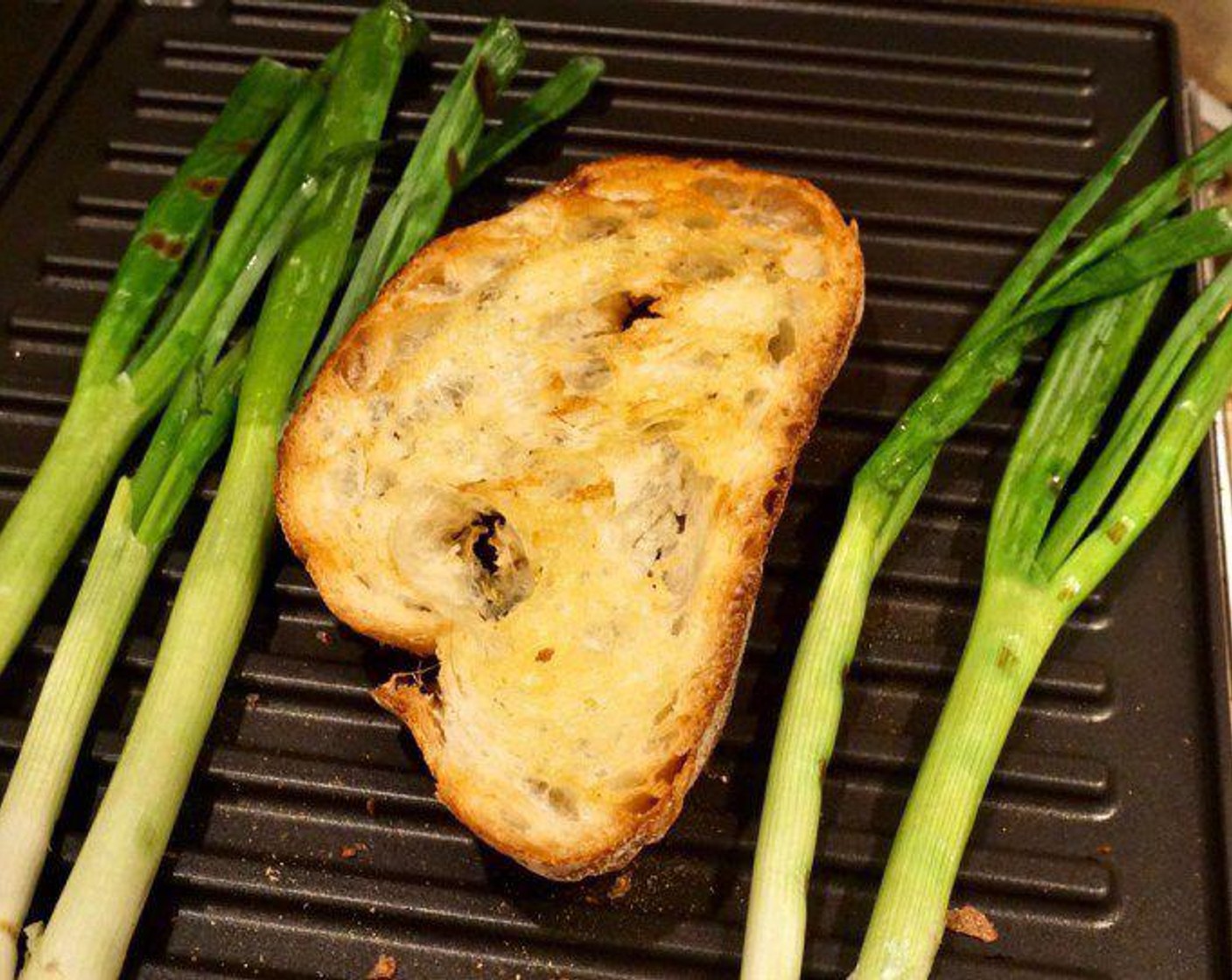 step 1 Drizzle Ciabatta Bread (8 slices) with Extra-Virgin Olive Oil (1/4 cup) and toast (or grill) the bread until golden or grill marks appear. If you want to add the scallions, grill Scallion (1 bunch) as well until starting to wilt and char.