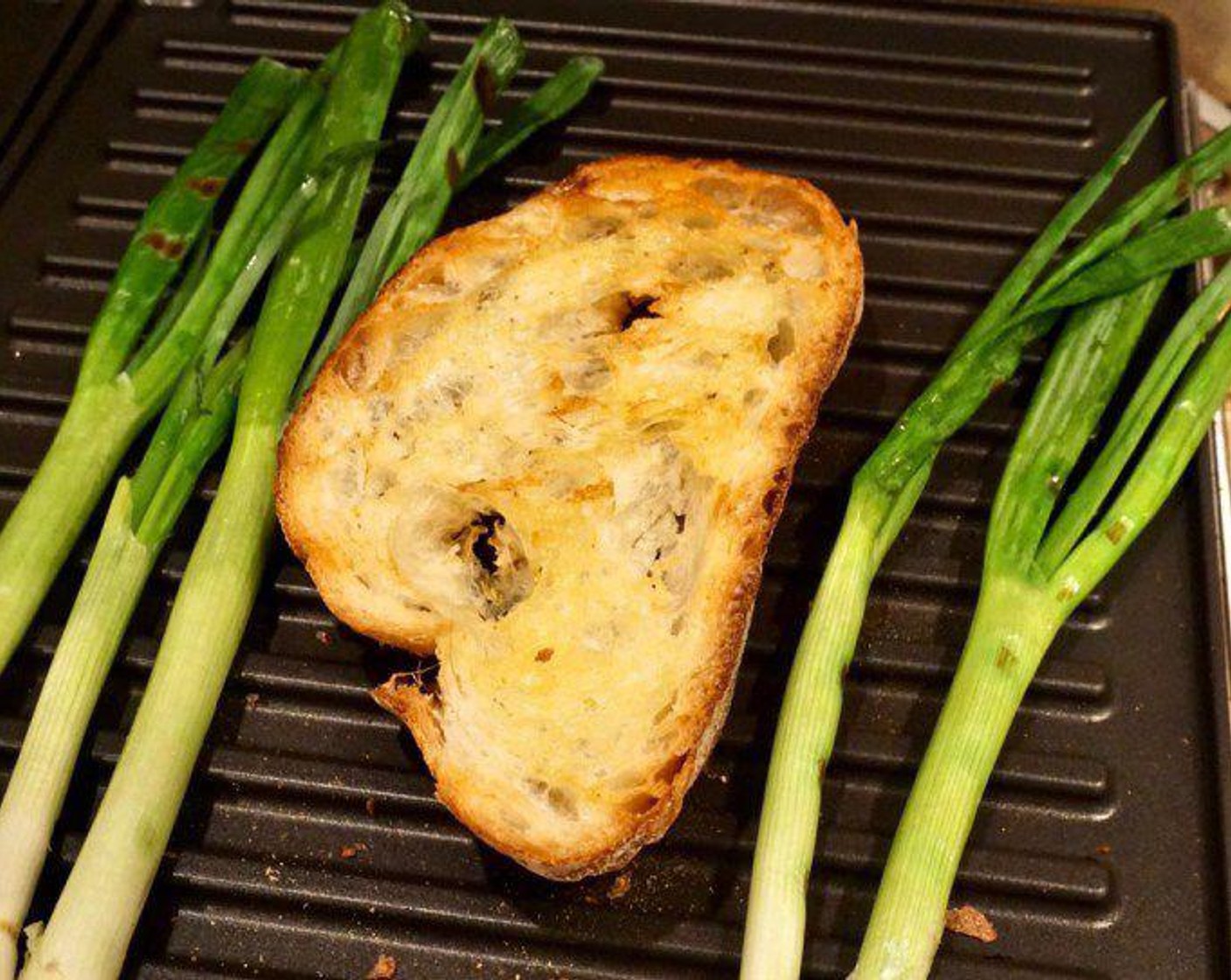 step 1 Drizzle Ciabatta Bread (8 slices) with Extra-Virgin Olive Oil (4 Tbsp) and toast (or grill) the bread until golden or grill marks appear. If you want to add the scallions, grill Scallion (1 bunch) as well until starting to wilt and char.