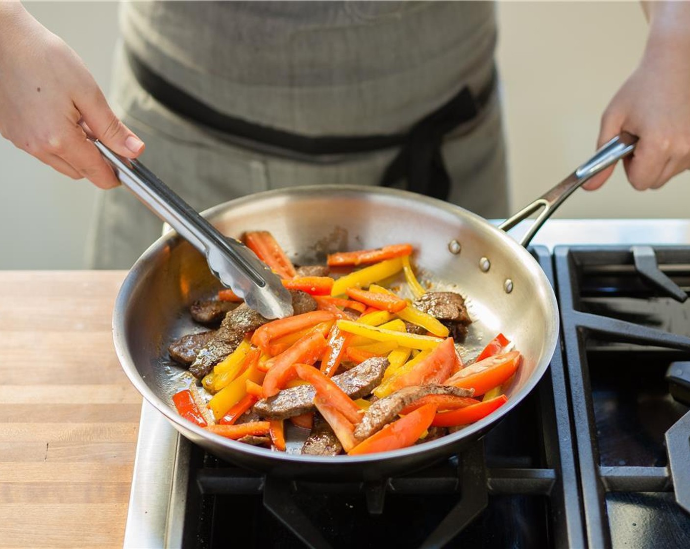 step 5 In the same pan, add Sesame Oil (1 Tbsp). When hot, add red and yellow bell pepper, ginger, garlic and sauté for 4-5 minutes or until crispy tender.