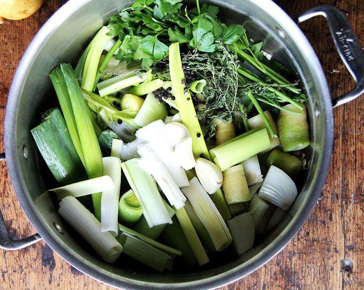 step 1 Combine everything: Yellow Onion (1), Carrots (2), Celery (1 stalk), {@11:}, Garlic (3 cloves), Fresh Parsley (4 sprigs), Fresh Thyme (4 sprigs), Tarragon (2 sprigs), Bay Leaf (1), Coarse Salt (1 tsp), Black Peppercorns (1 tsp), and {@10:} in a pot. Bring to a boil, lower the heat, and simmer for forty-five minutes.