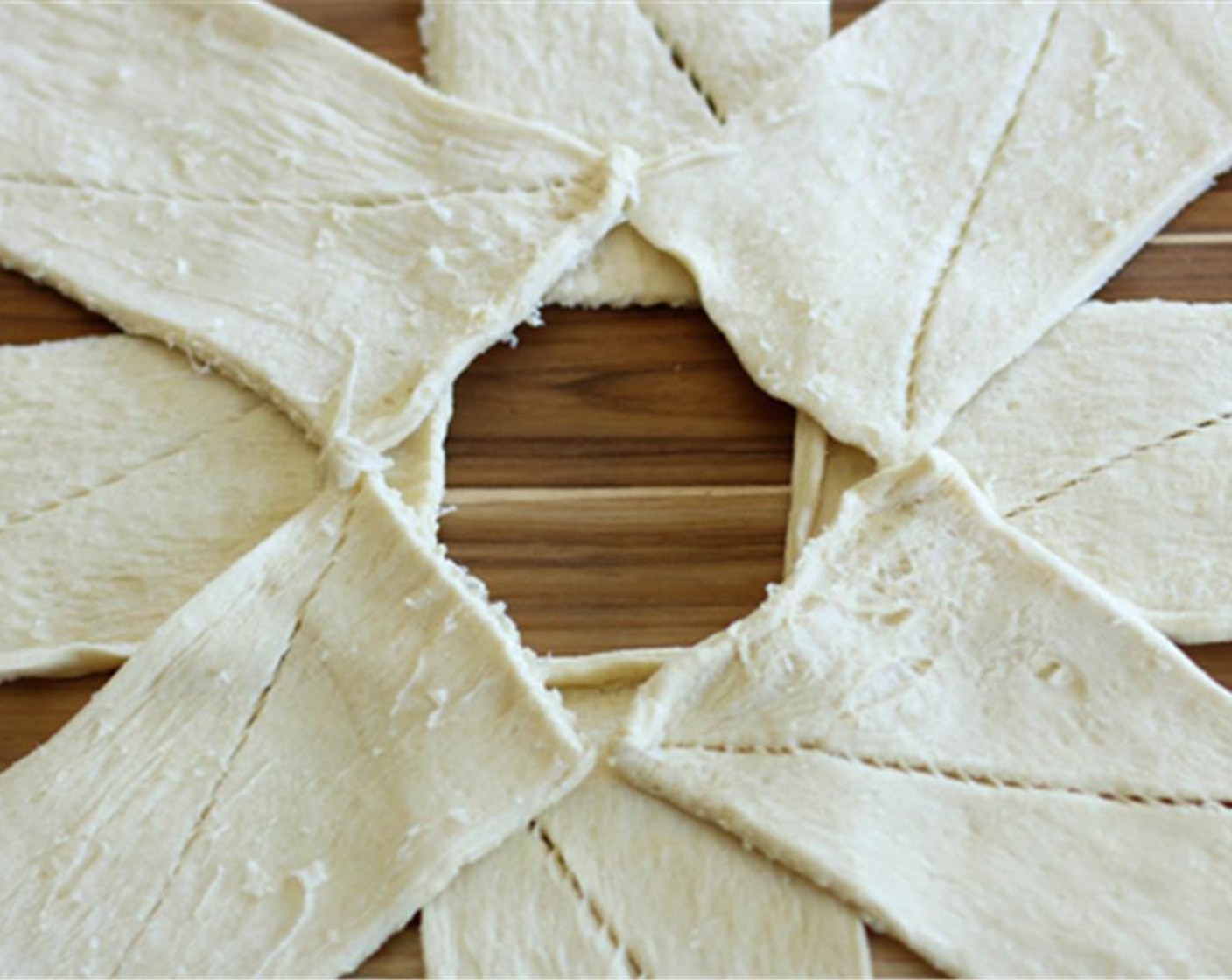 step 5 Using the rest of the Crescent Roll Dough (1 can) and separate the dough into 4 rectangles (2 crescents per section) and fill in the gaps in the first layer.