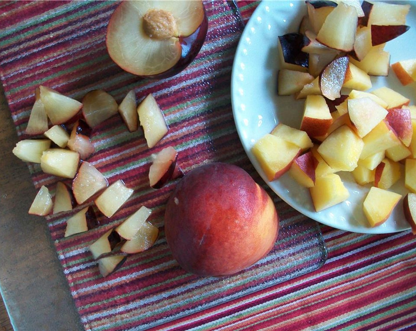 step 5 Slice and dice the Peach (1 cup) and Plum (1 cup) and combine. Put a 1/2 cup of the chopped fruit aside. This will grace the top later.