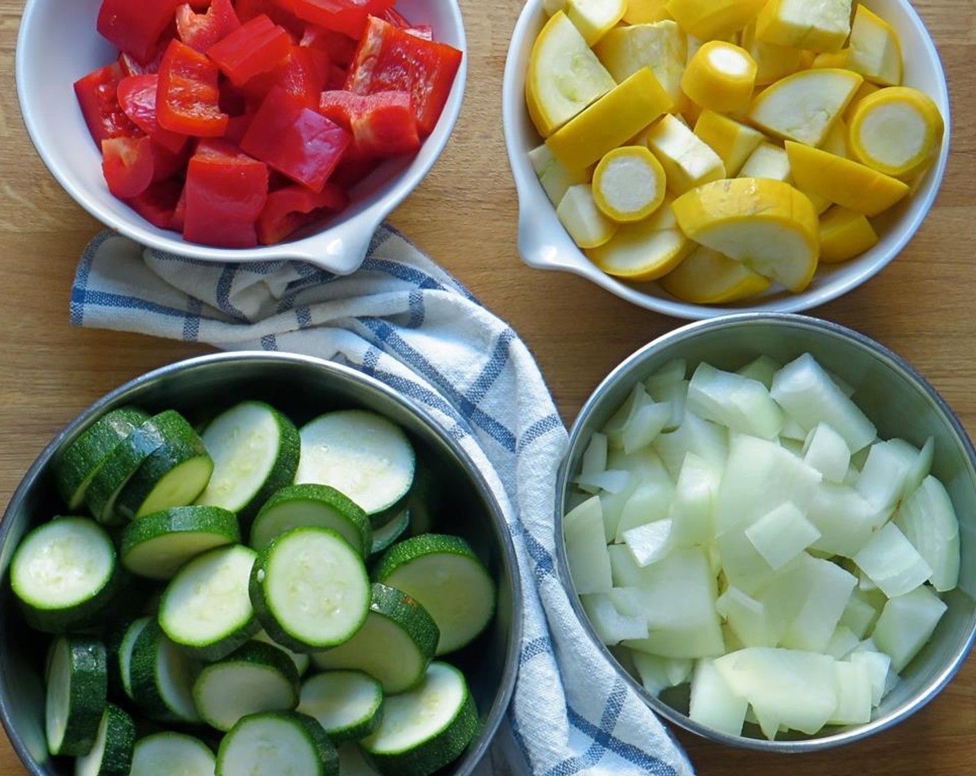 step 1 Cut the Red Bell Pepper (1), Zucchini (2), and Yellow Squash (2) into 1-inch pieces. Dice the Yellow Onion (1).