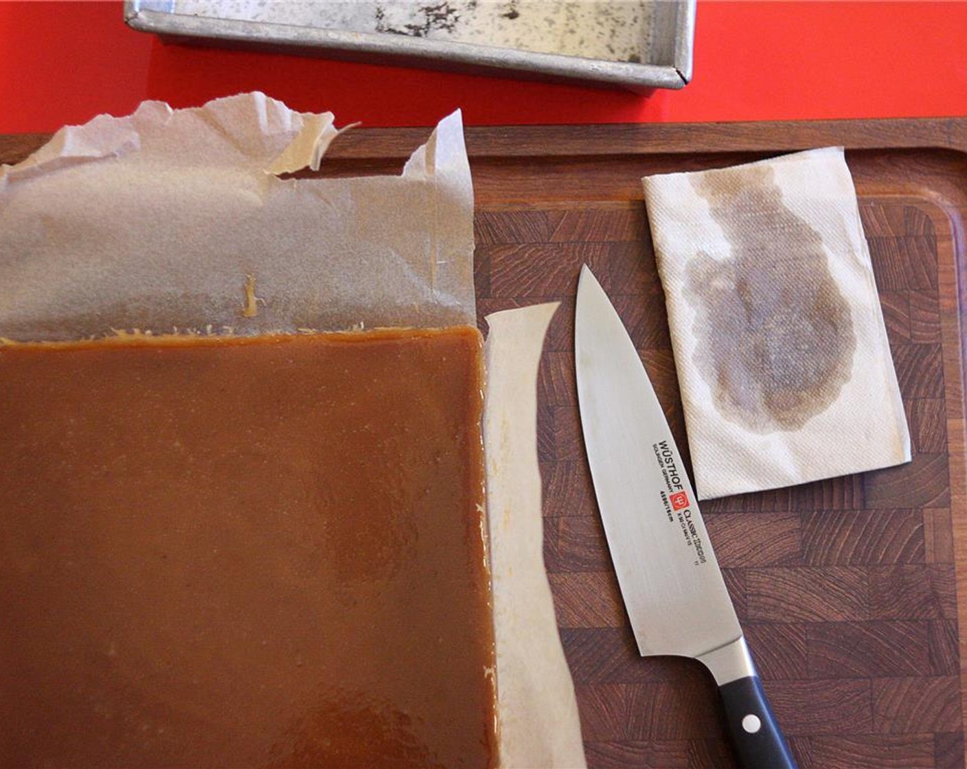 step 7 Once caramel block has cooled, use the parchment sling to lift the block out of the pan and onto a cutting board. Wipe Vegetable Oil (as needed) on both sides of a knife and cut into one-inch wide strips, re-oiling the knife after each cut.